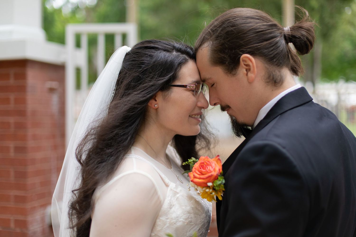 Close-up wedding portrait showing tender moment between couple on their special day.