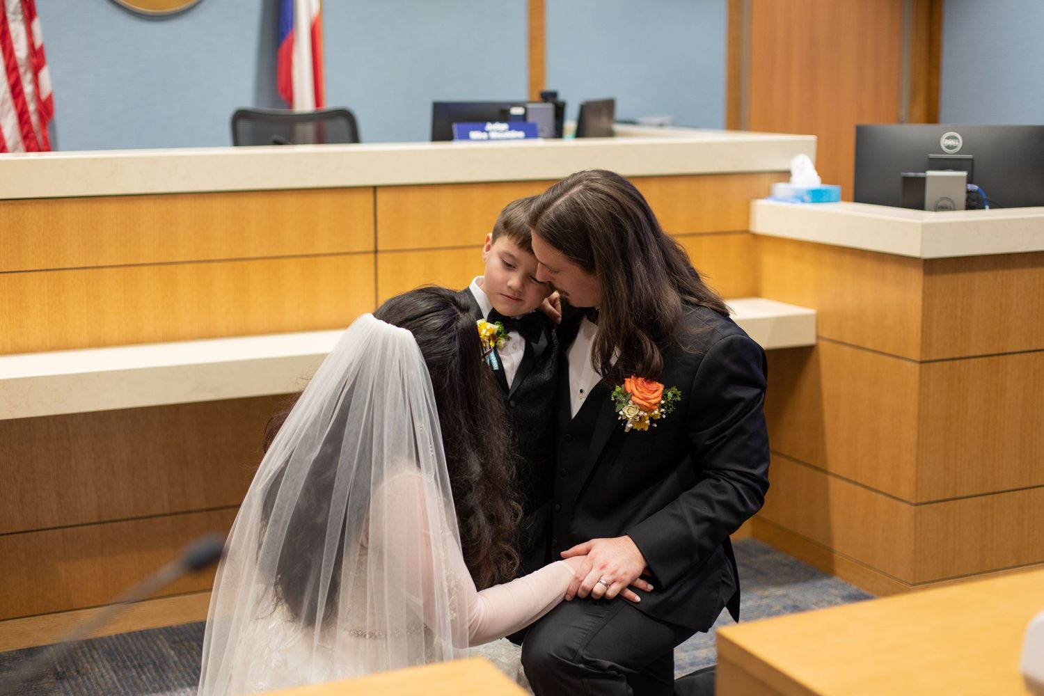 A couple shares a romantic moment during their courthouse wedding ceremony.