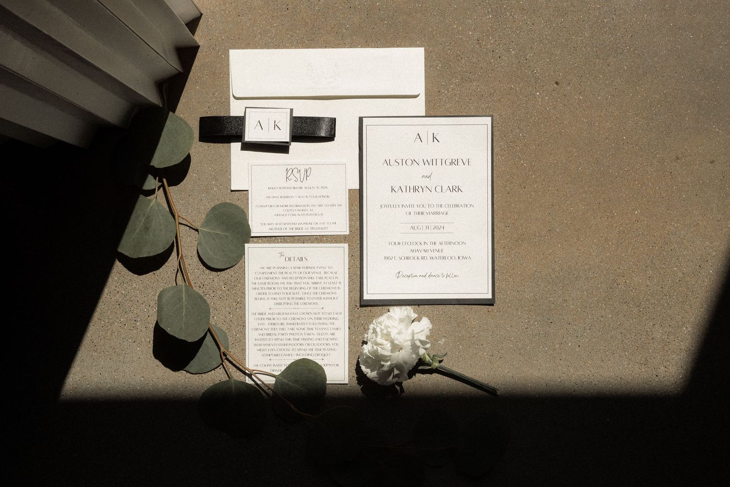 Wedding invitations and stationery arranged on a neutral background.