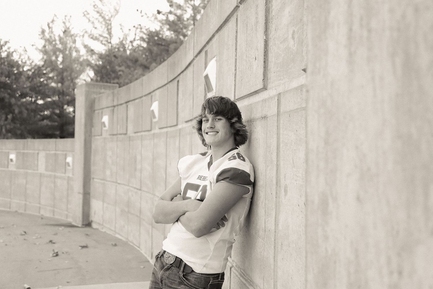 Casual portrait against a curved concrete wall showing playful expressions.