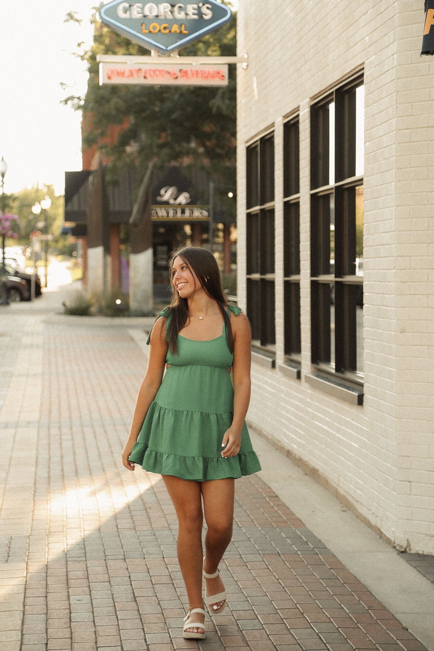 Street fashion photos in front of urban storefronts showing green summer dress and casual style.