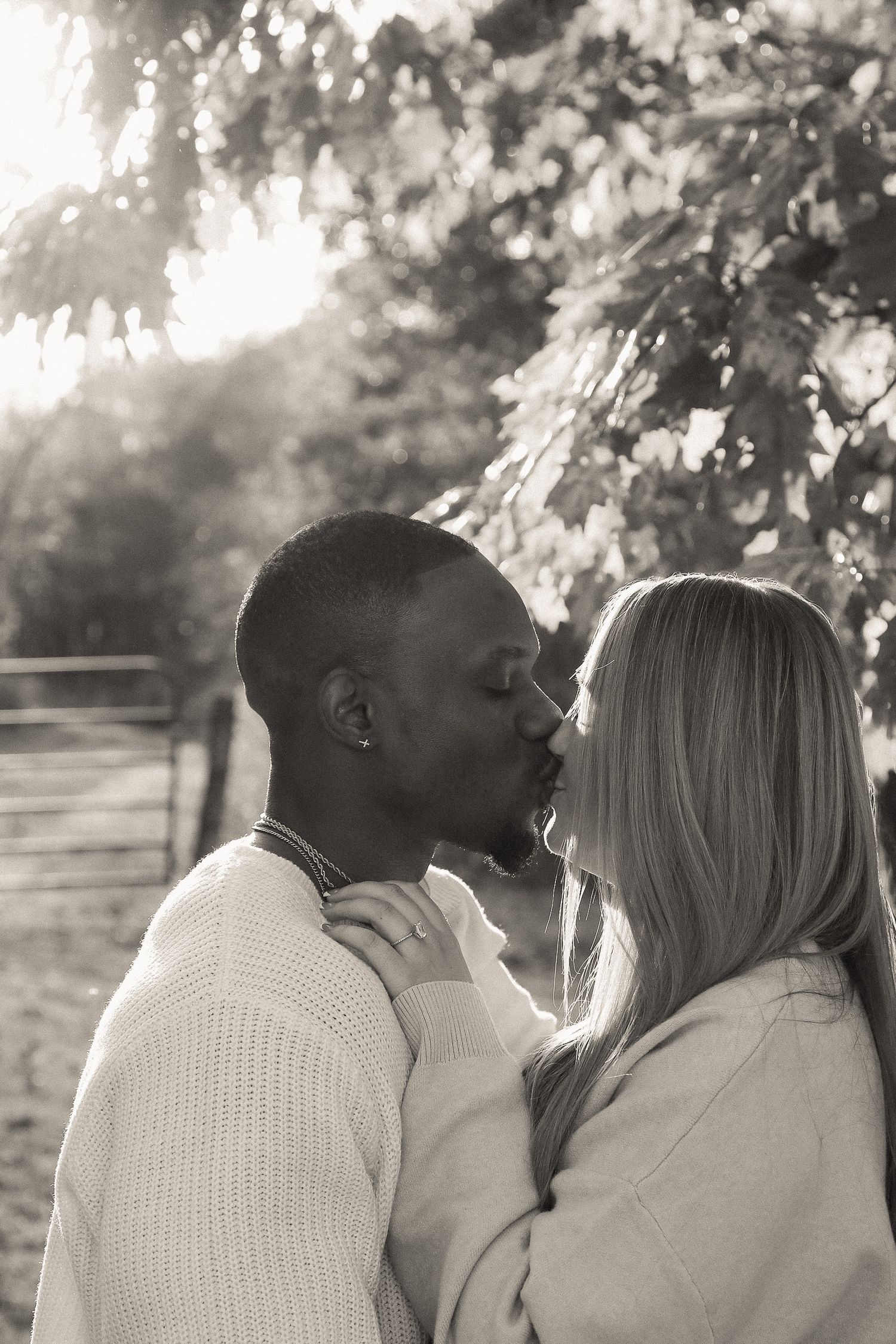 Intimate black and white portraits of couple in cozy sweaters outdoors.