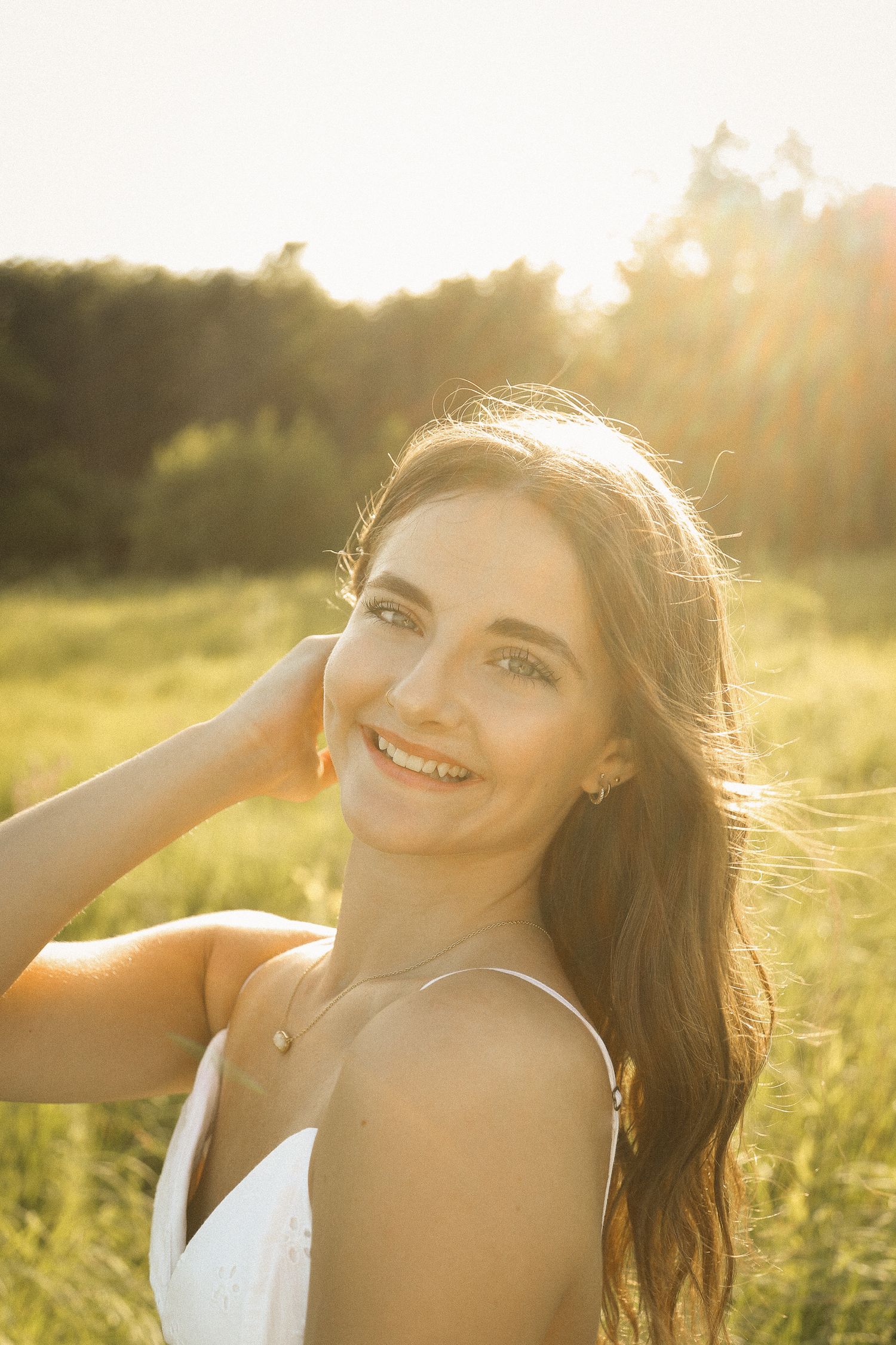 Golden sunlight creates a warm glow during a summer outdoor portrait session.