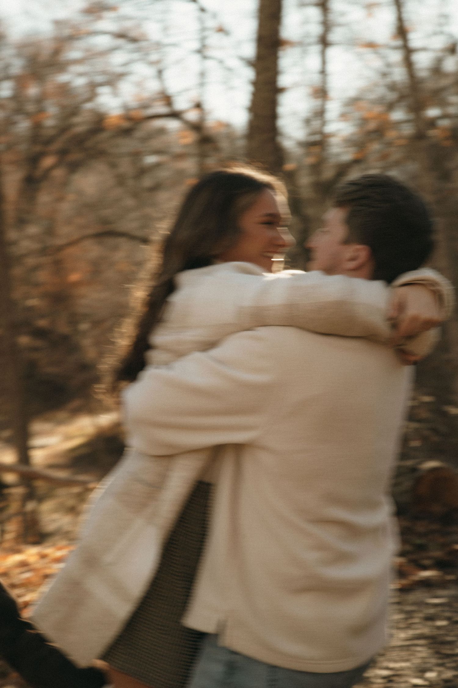 Artistic sequence of a couple embracing in warm cream sweaters against autumn trees.