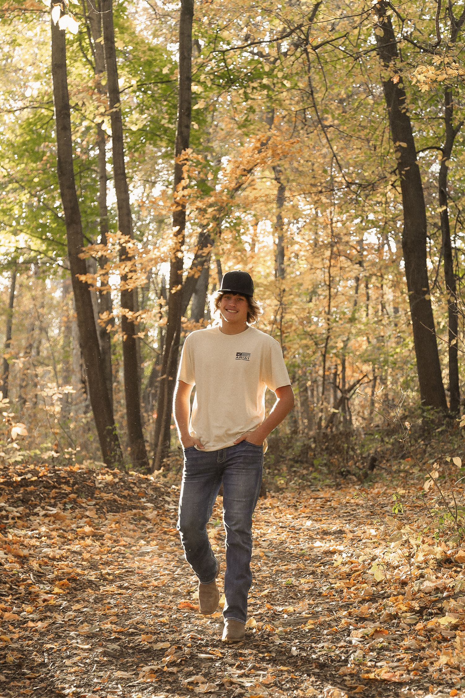 Walking sequence through autumn forest with fallen leaves and filtered sunlight.