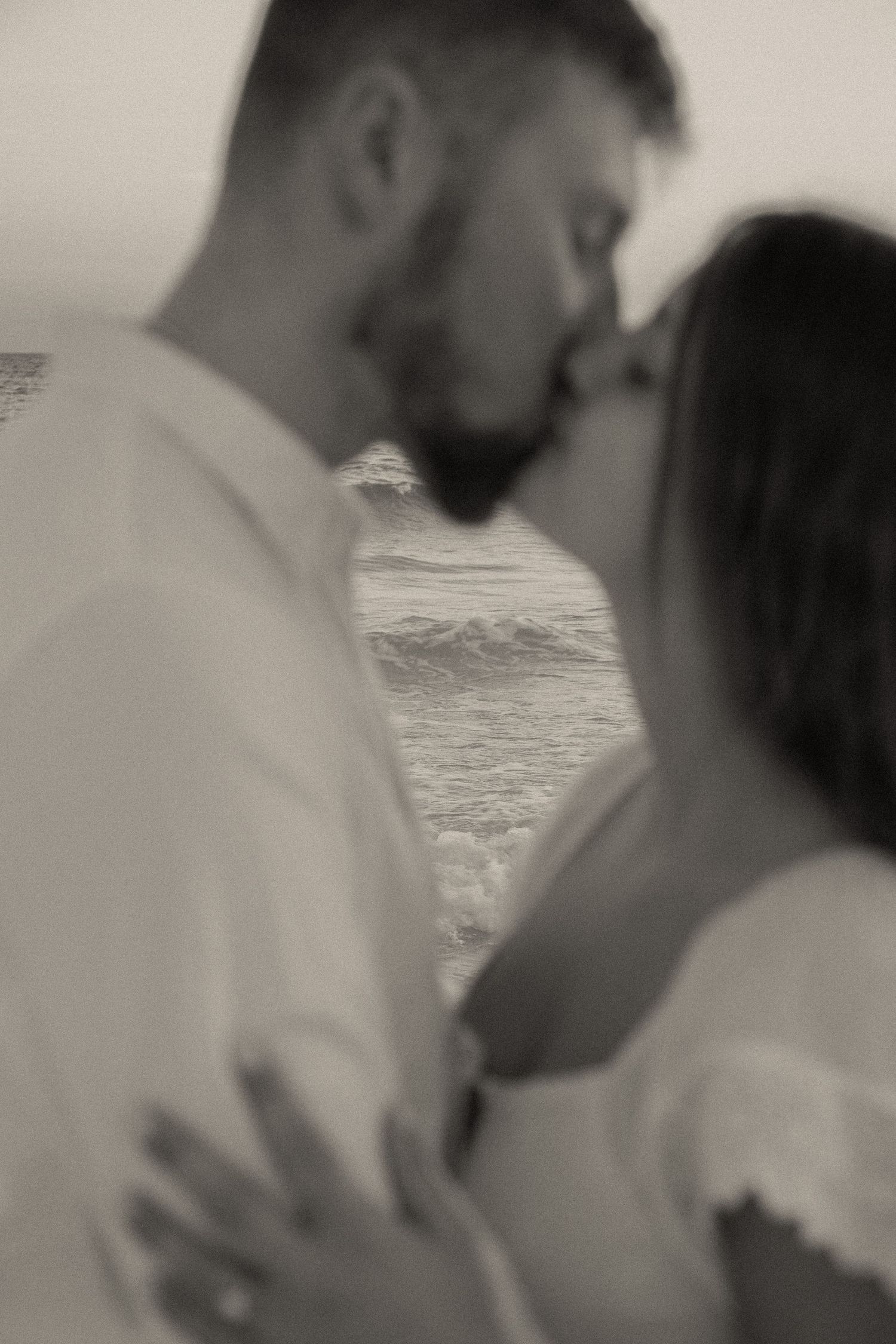 Close-up black and white portrait of couple sharing tender moment.