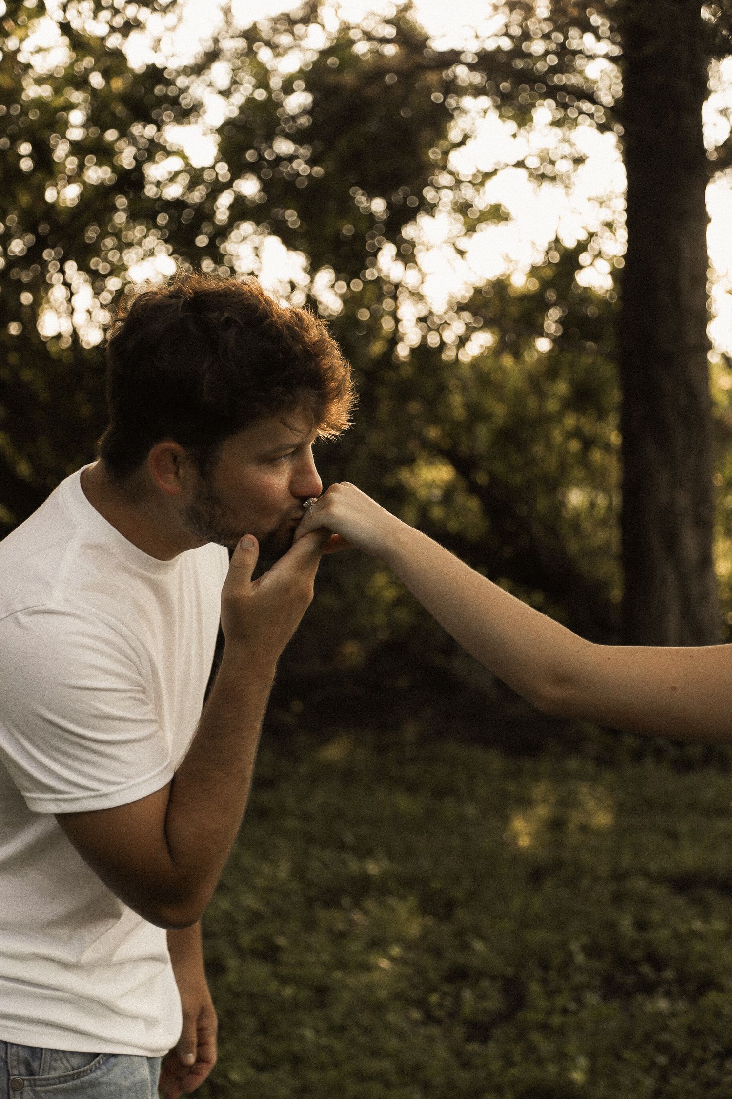 Artistic sequence showing person in white shirt kissing a hand in warm sunset lighting.