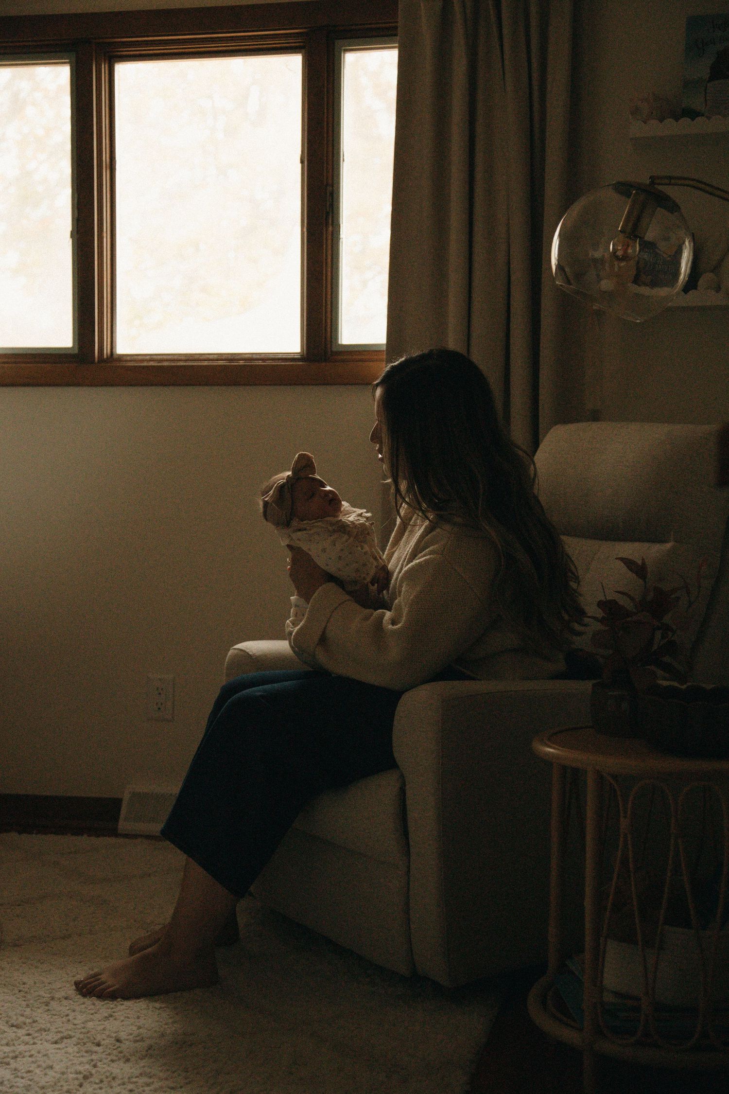 A peaceful scene of relaxation in a dimly lit living room with natural window light.