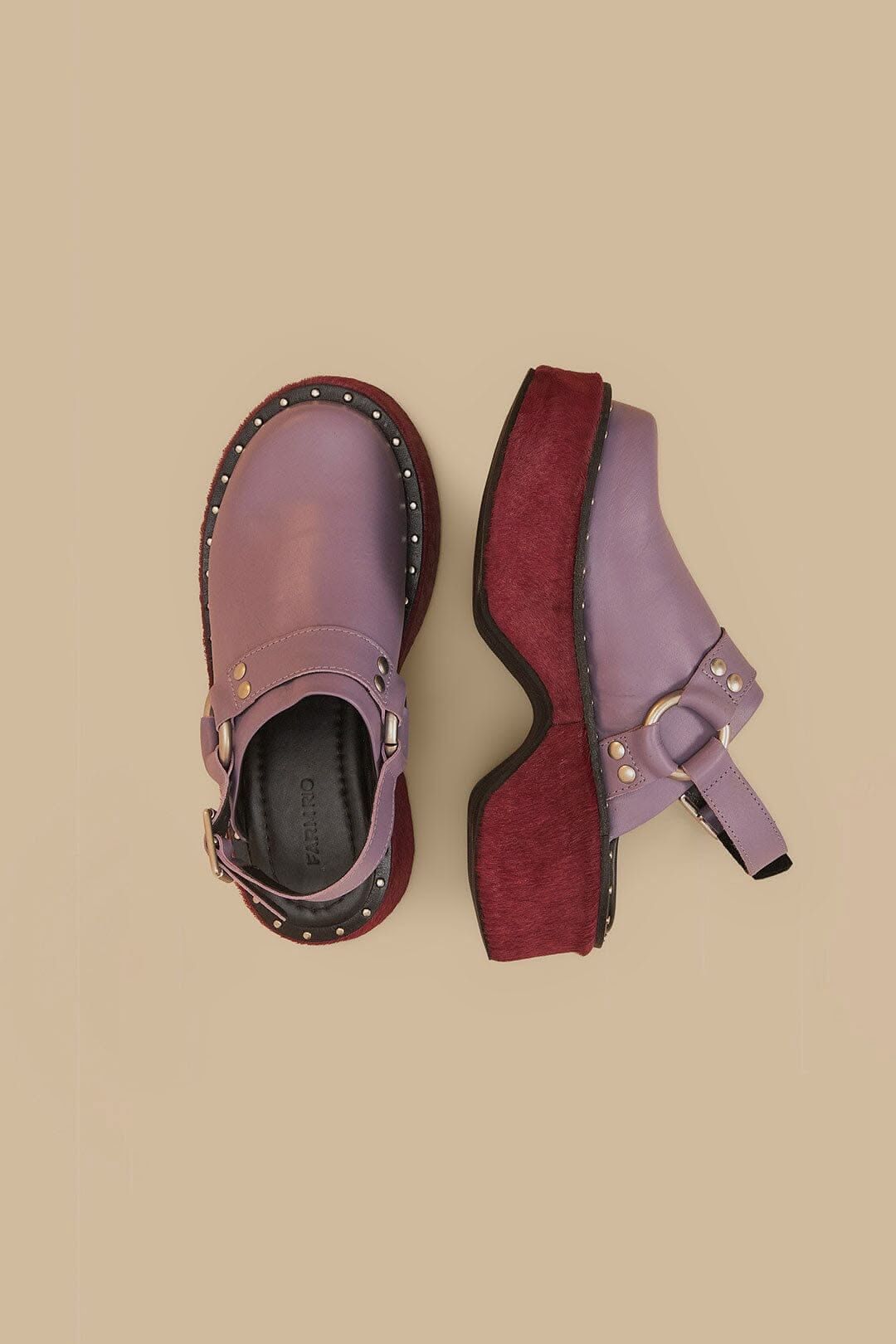 Purple leather clogs with gold studs, buckle strap, and burgundy platform sole, shown from top view.