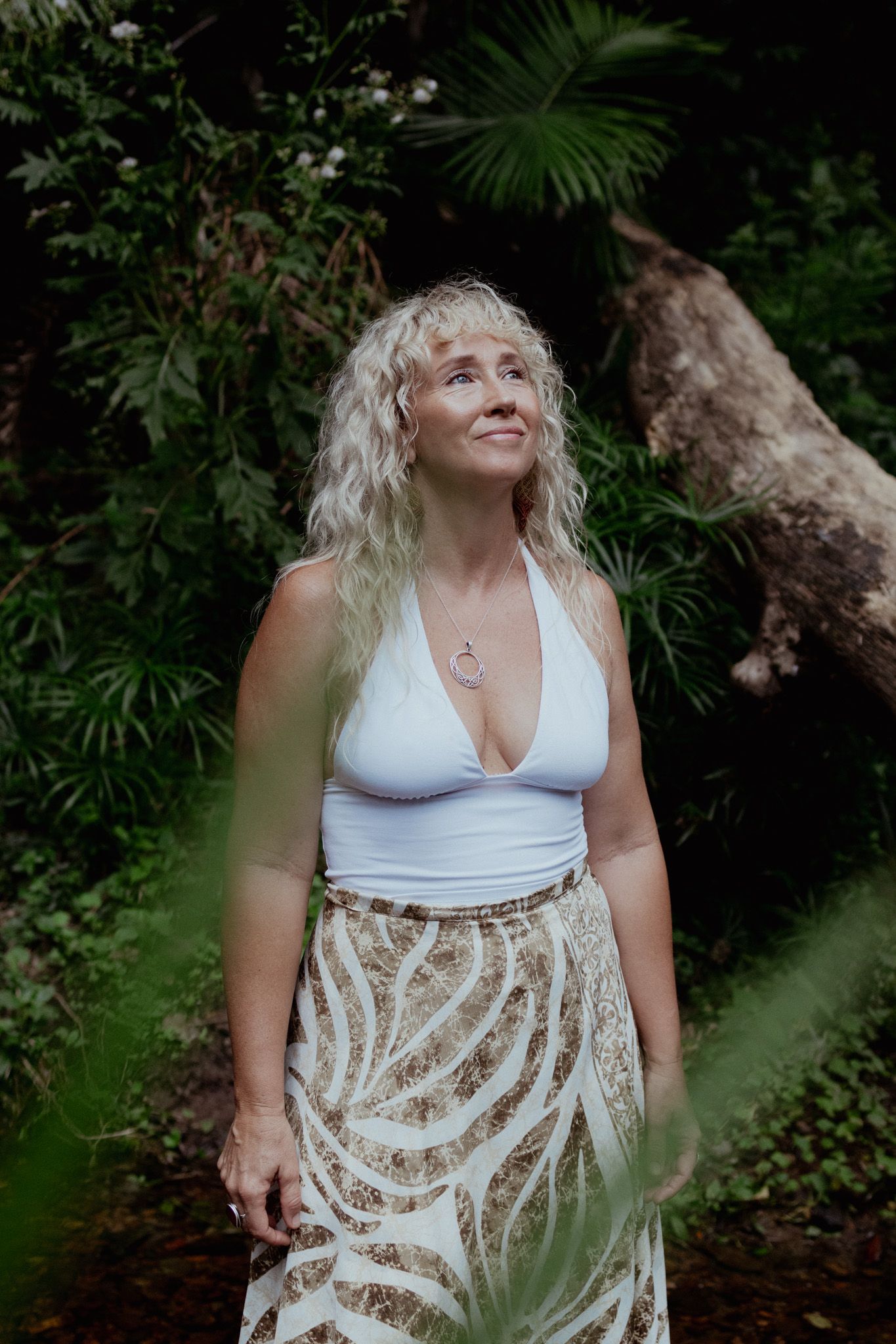 Garden photoshoot setting with lush tropical plants creating a natural backdrop.