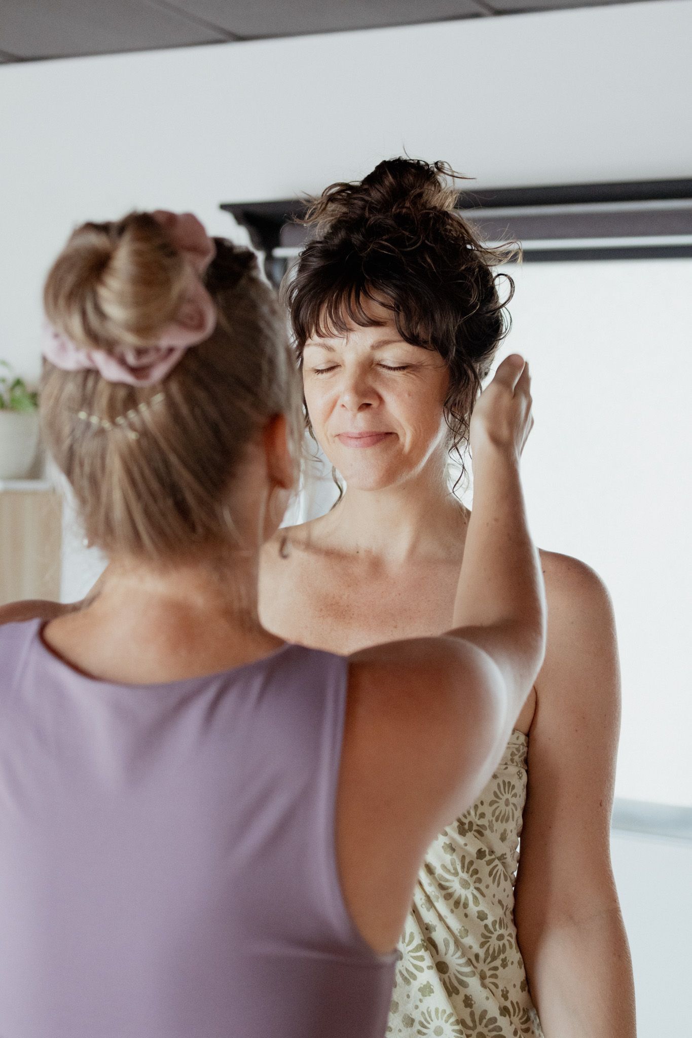 Intimate moments captured during a wellness or spa session in soft lighting.