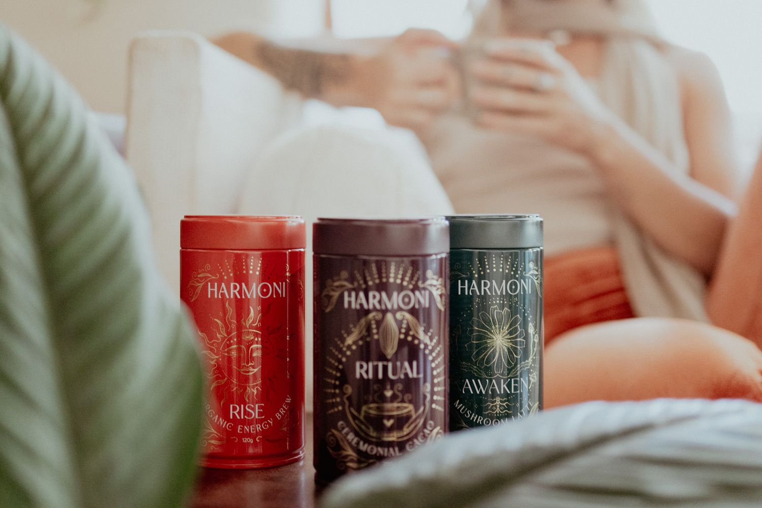 Row of decorative candles in red and brown tones with elegant packaging.