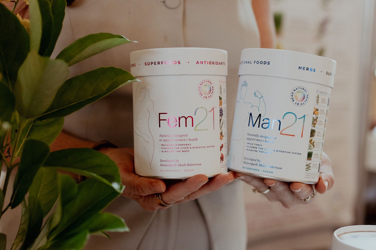 White skincare product containers displayed with minimalist branding and natural elements.