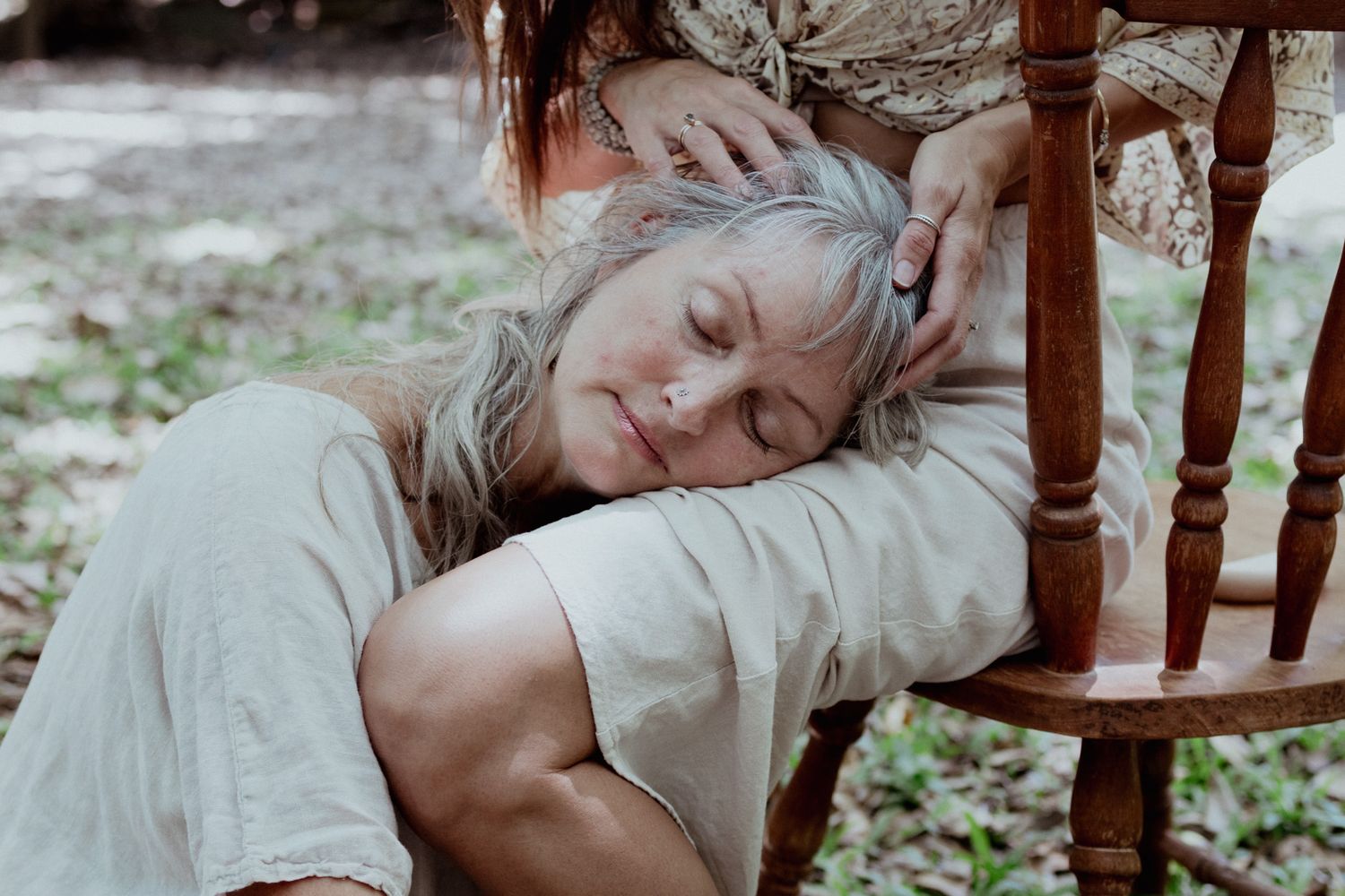 A series of ethereal portraits showing someone resting on a wooden chair in soft lighting.