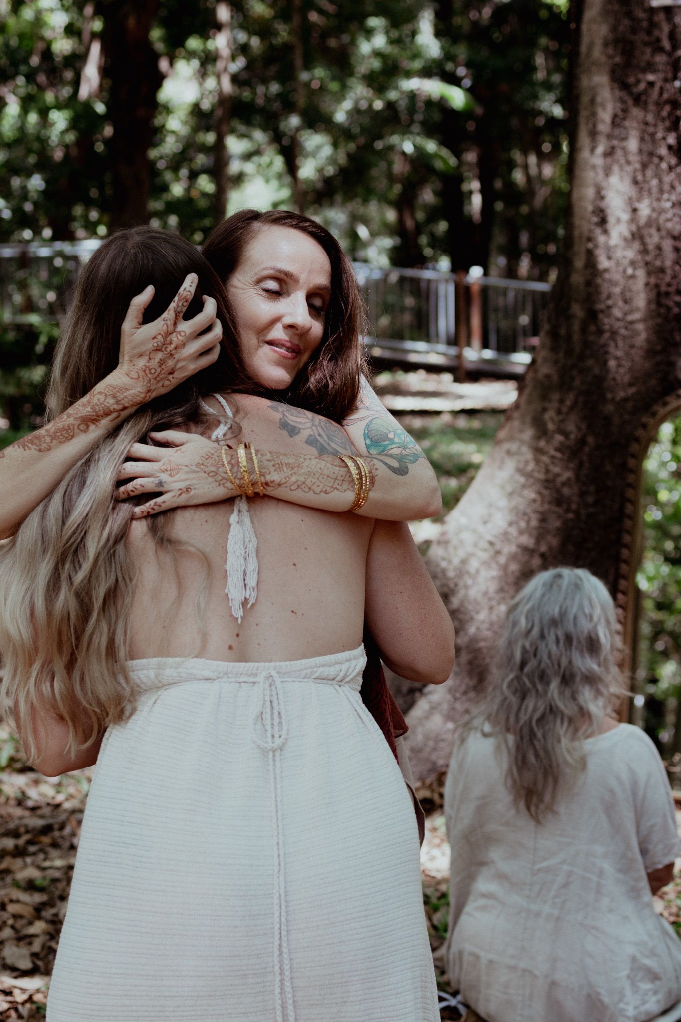 A series of ethereal photos showing hands gently braiding long hair in a sunlit forest setting.