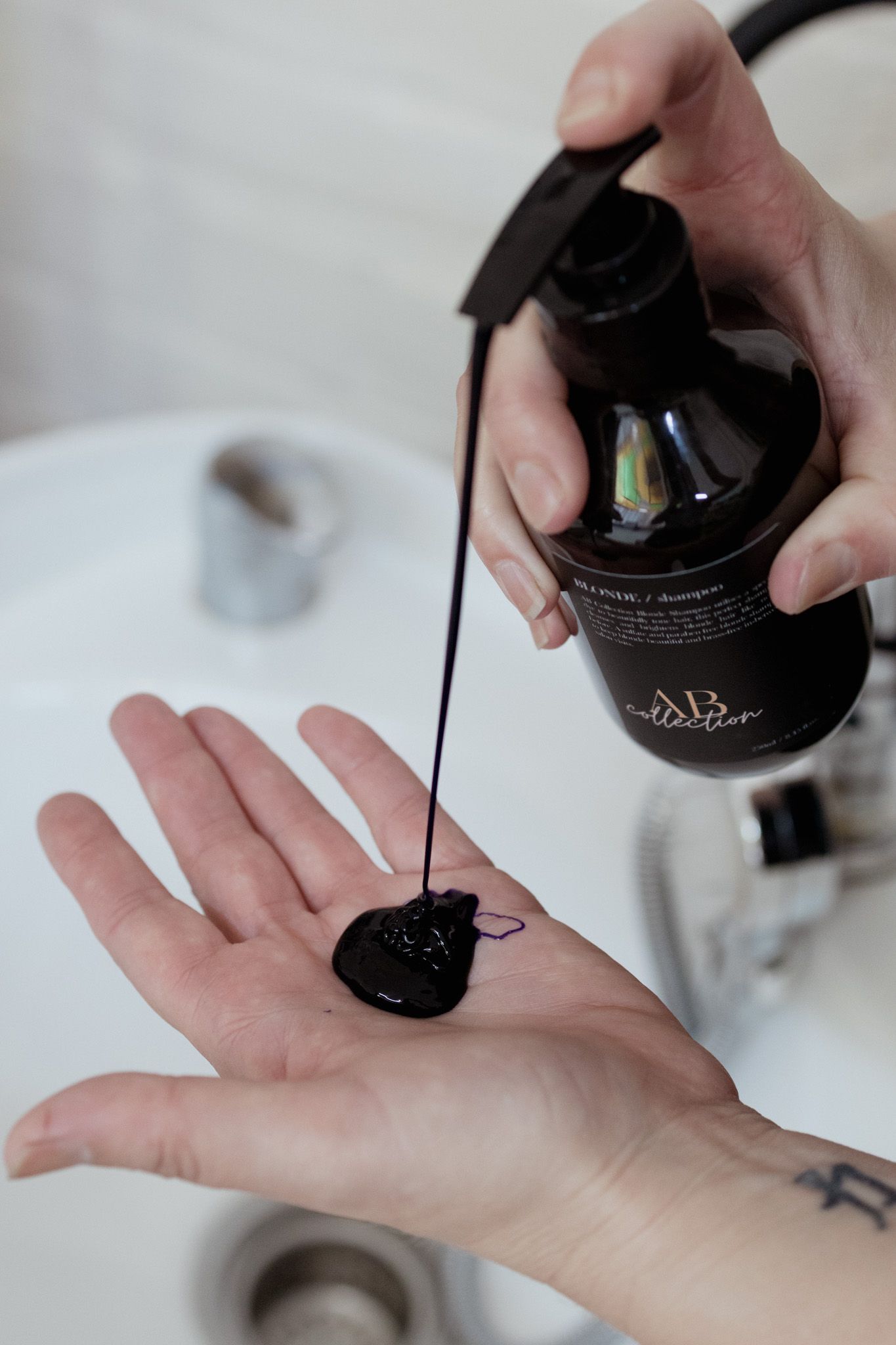 Step-by-step demonstration of black nail polish application on a hand.