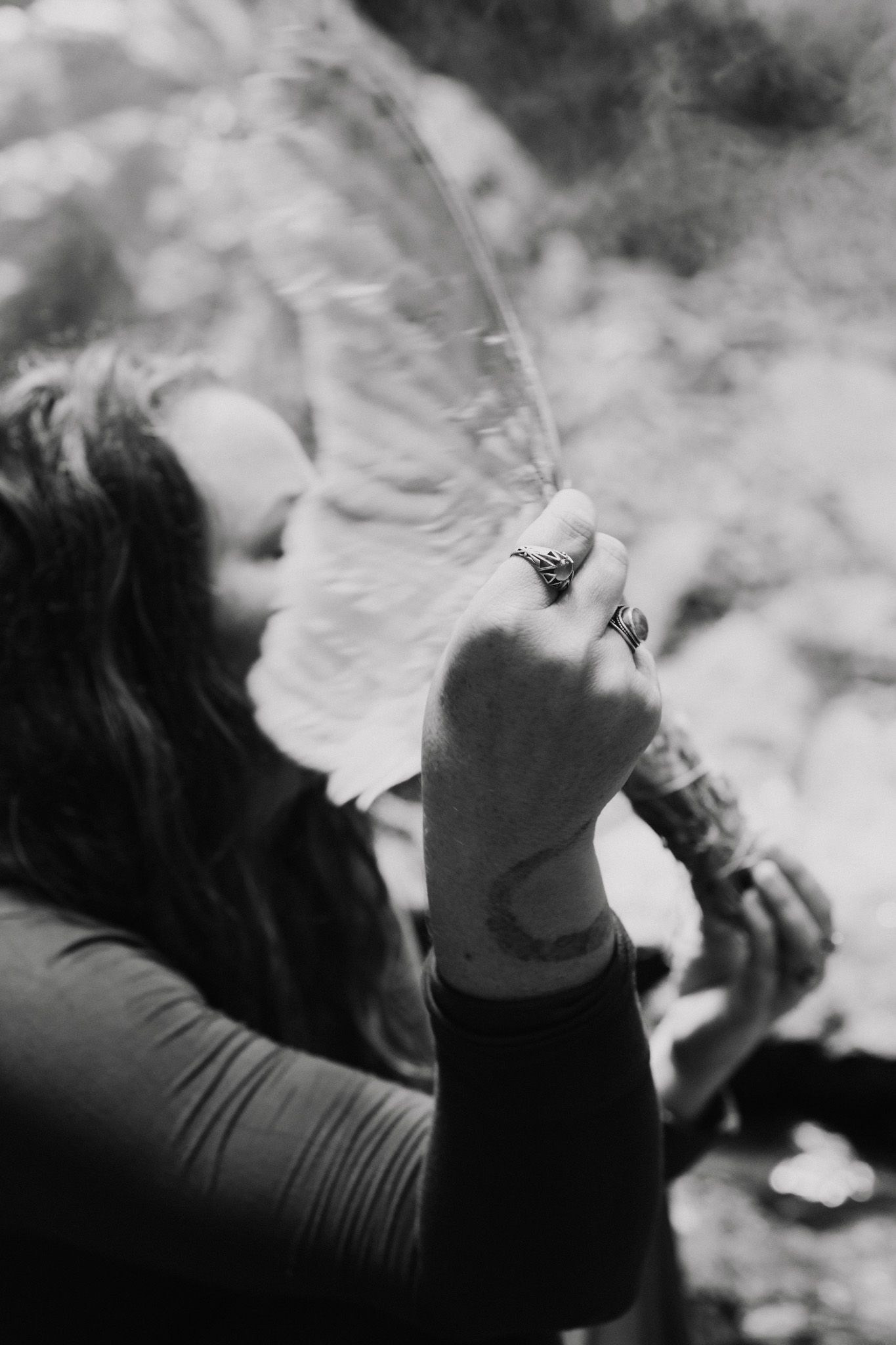 Series of black and white photos showing hands and smoke in natural lighting.