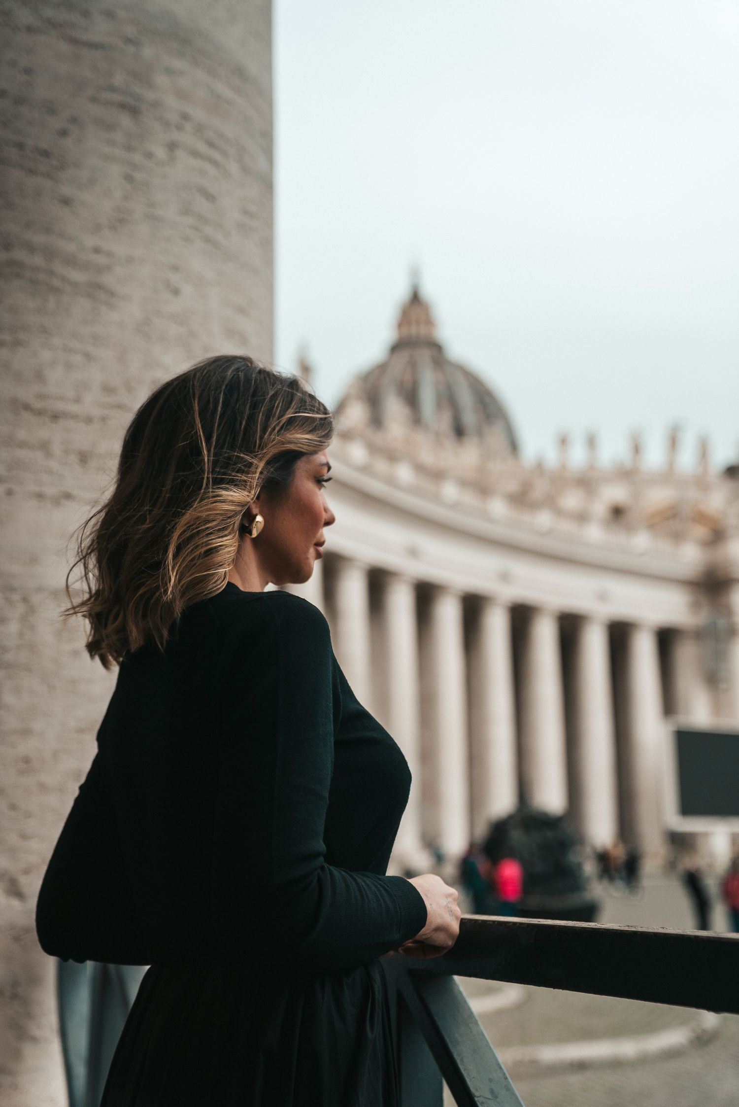 Silhouette against the grand architecture of St. Peter's Basilica in Vatican City.