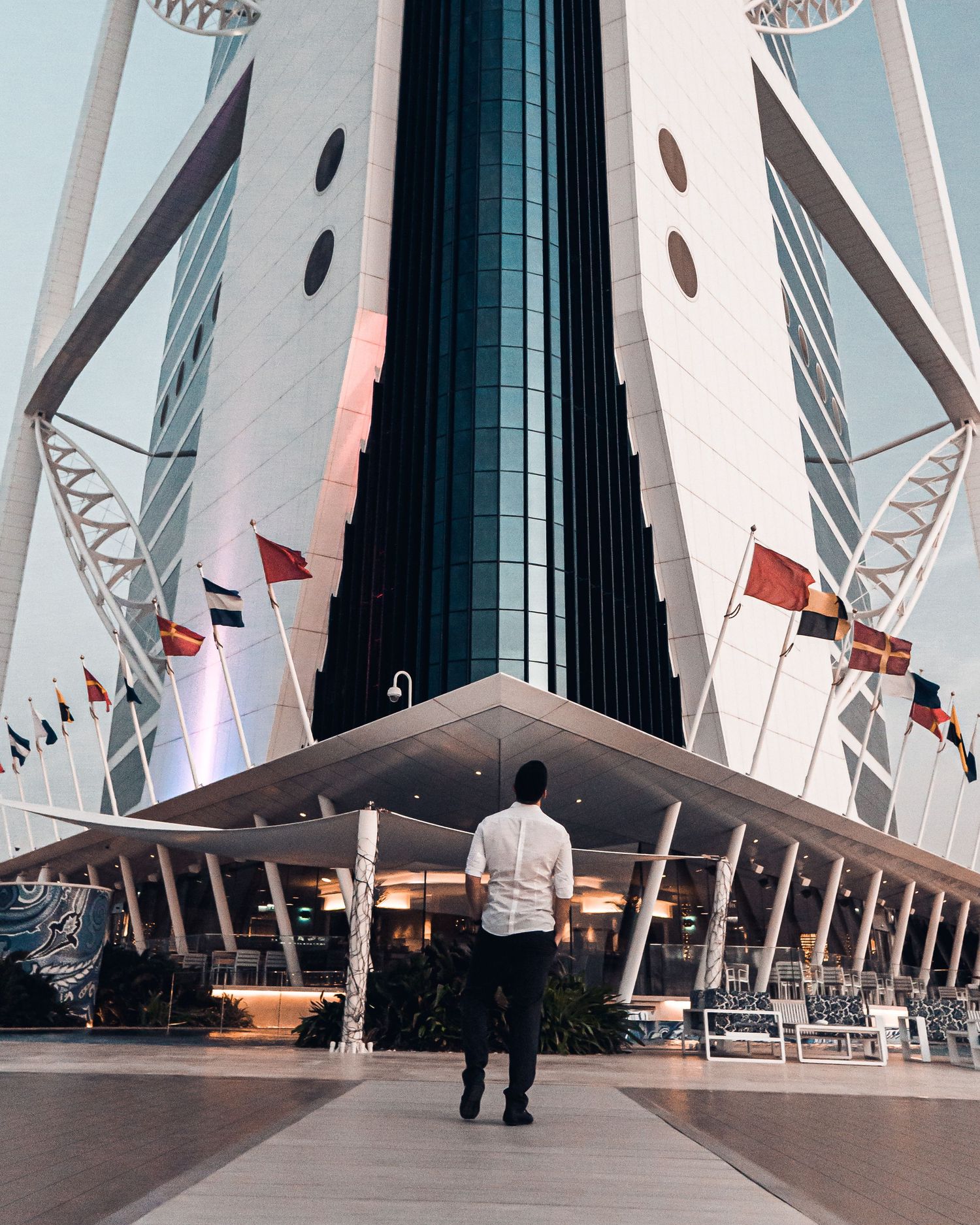 Modern architectural building with angular white beams and geometric patterns viewed from different perspectives.