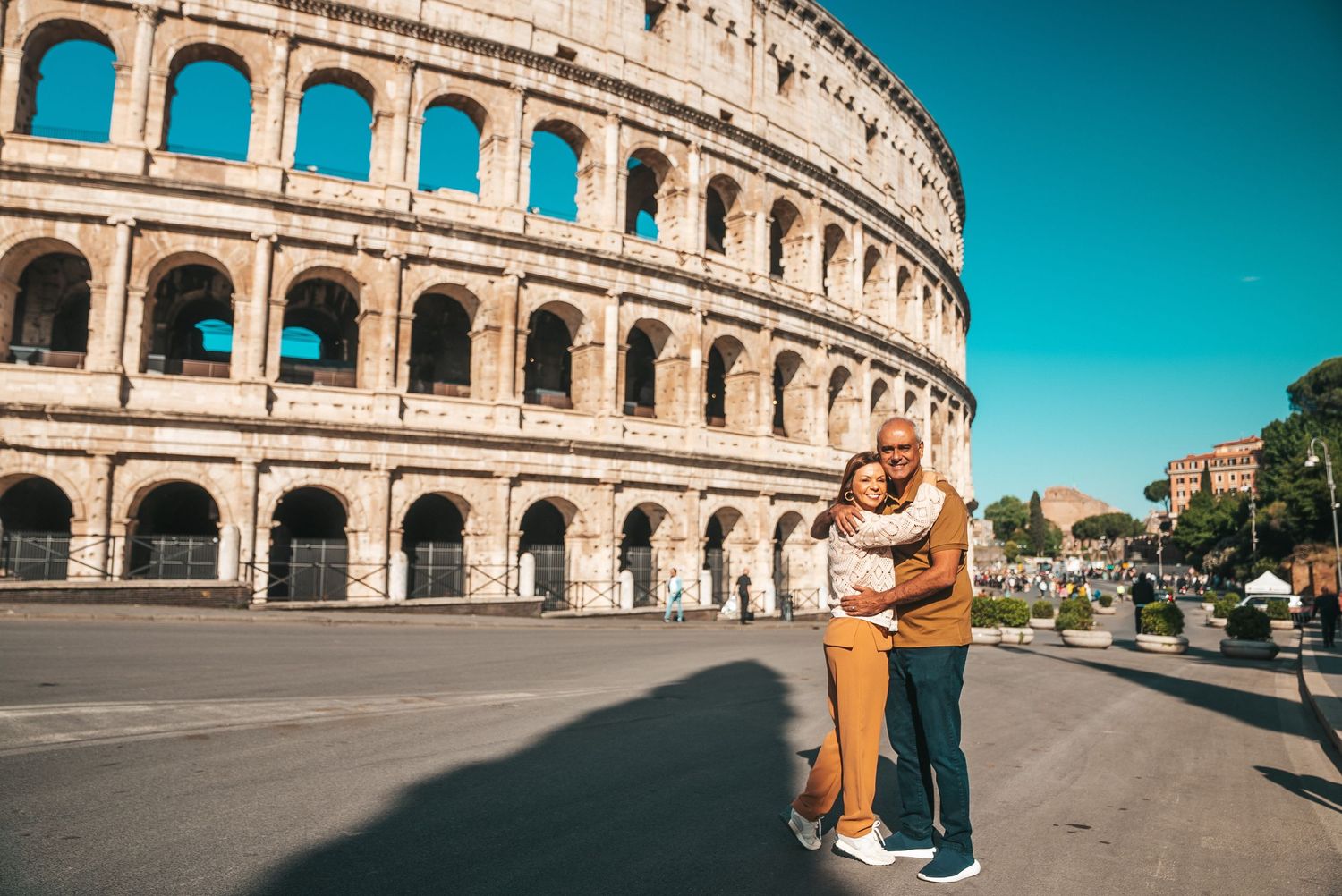 Exterior view of the Roman Colosseum with tourists admiring the ancient amphitheater.