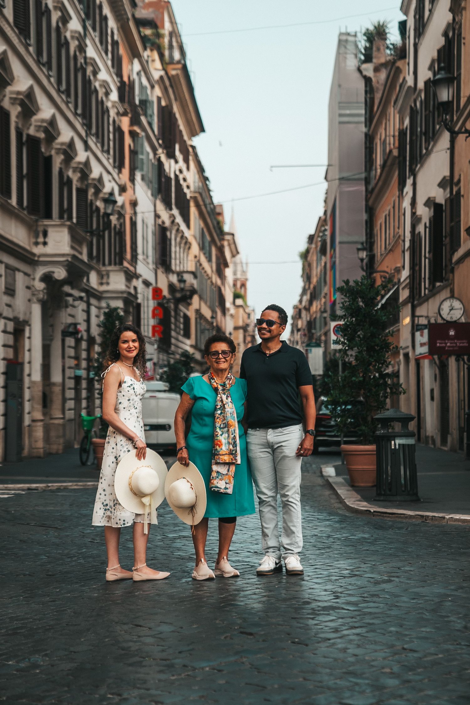Group of tourists exploring a charming cobblestone street in Rome's historic center.