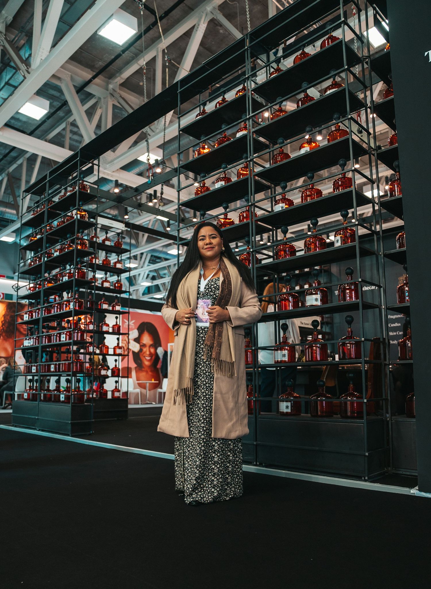 Industrial space with rows of hanging red product displays and dramatic lighting.