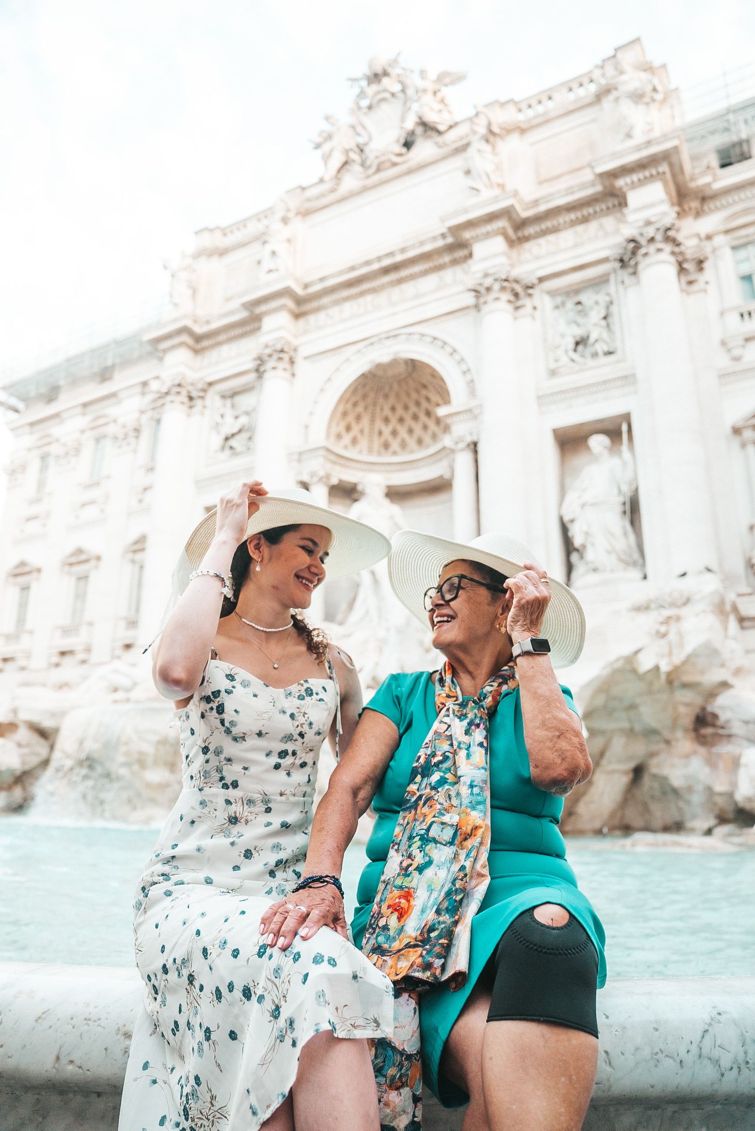 Tourists enjoying a moment together at the historic Trevi Fountain in Rome.