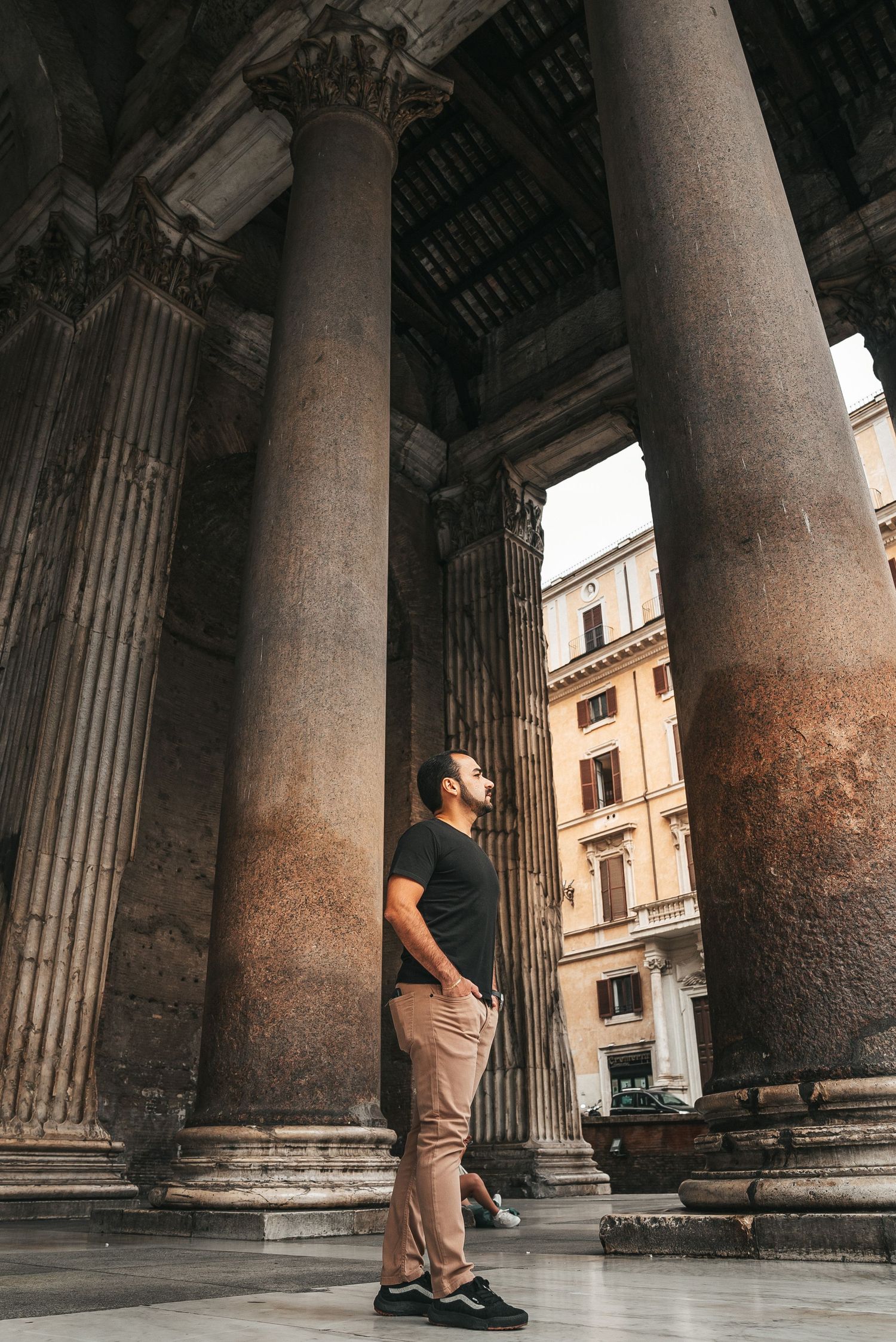 Person standing between ancient stone columns at the Pantheon in Rome, captured from multiple angles in sequence.