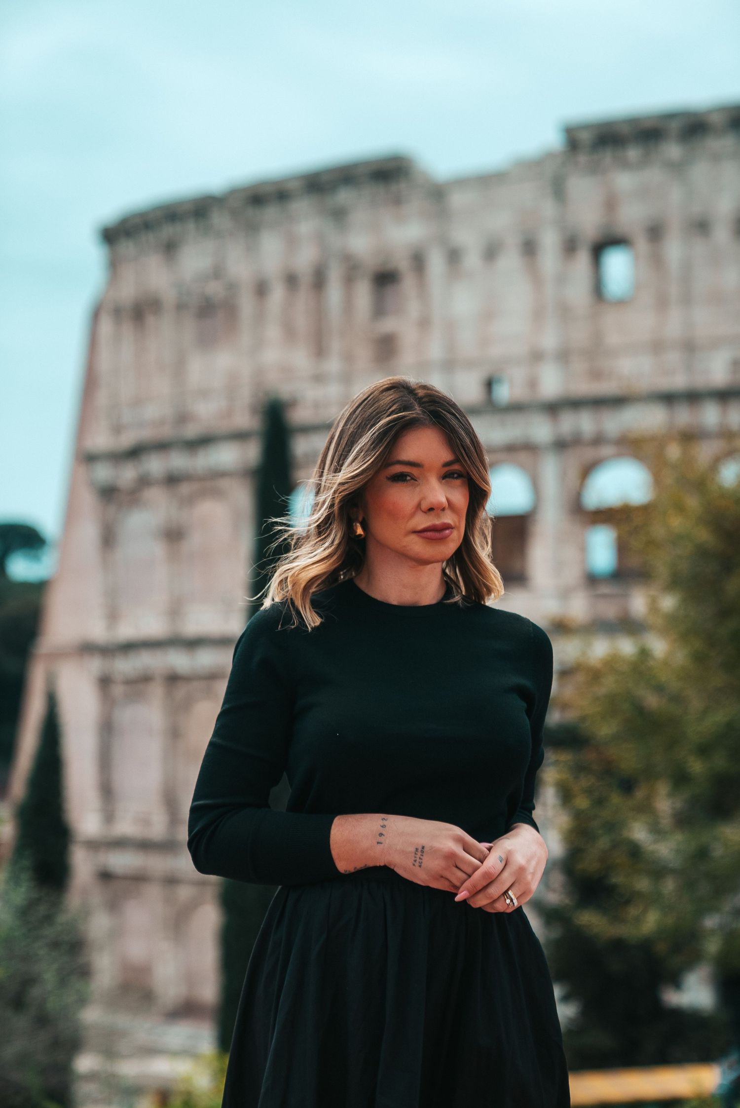 Artistic portrait session with the Colosseum as a dramatic backdrop.