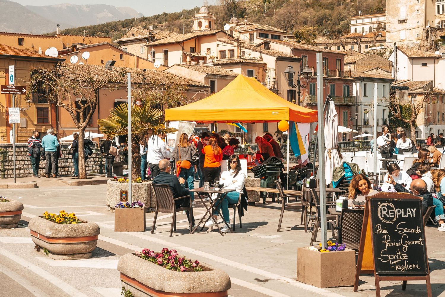A collage of outdoor cafe scenes showing patio dining spaces with umbrellas, planters and restaurant seating areas.