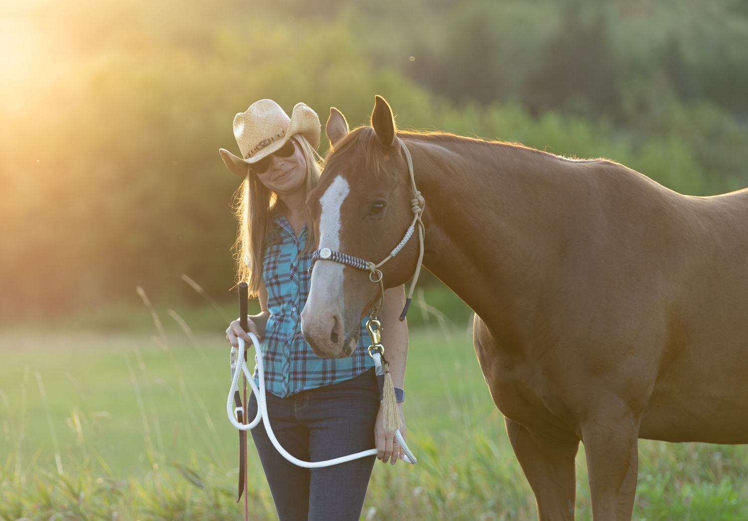 Woman with her horse at sunset