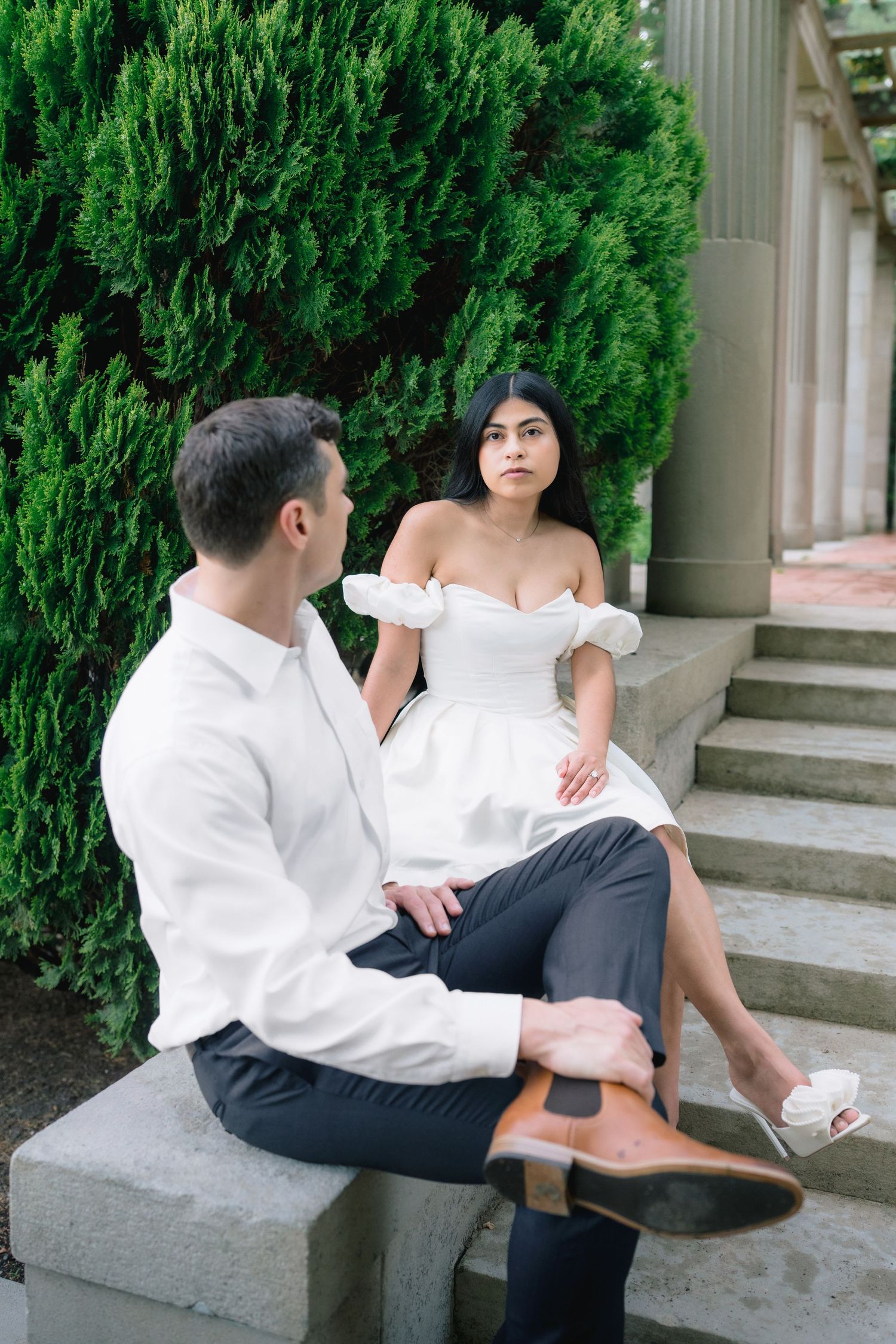 Editorial engagement portrait of a couple sitting on the historic stone steps at Harkness Memorial State Park in Waterford, Connecticut.