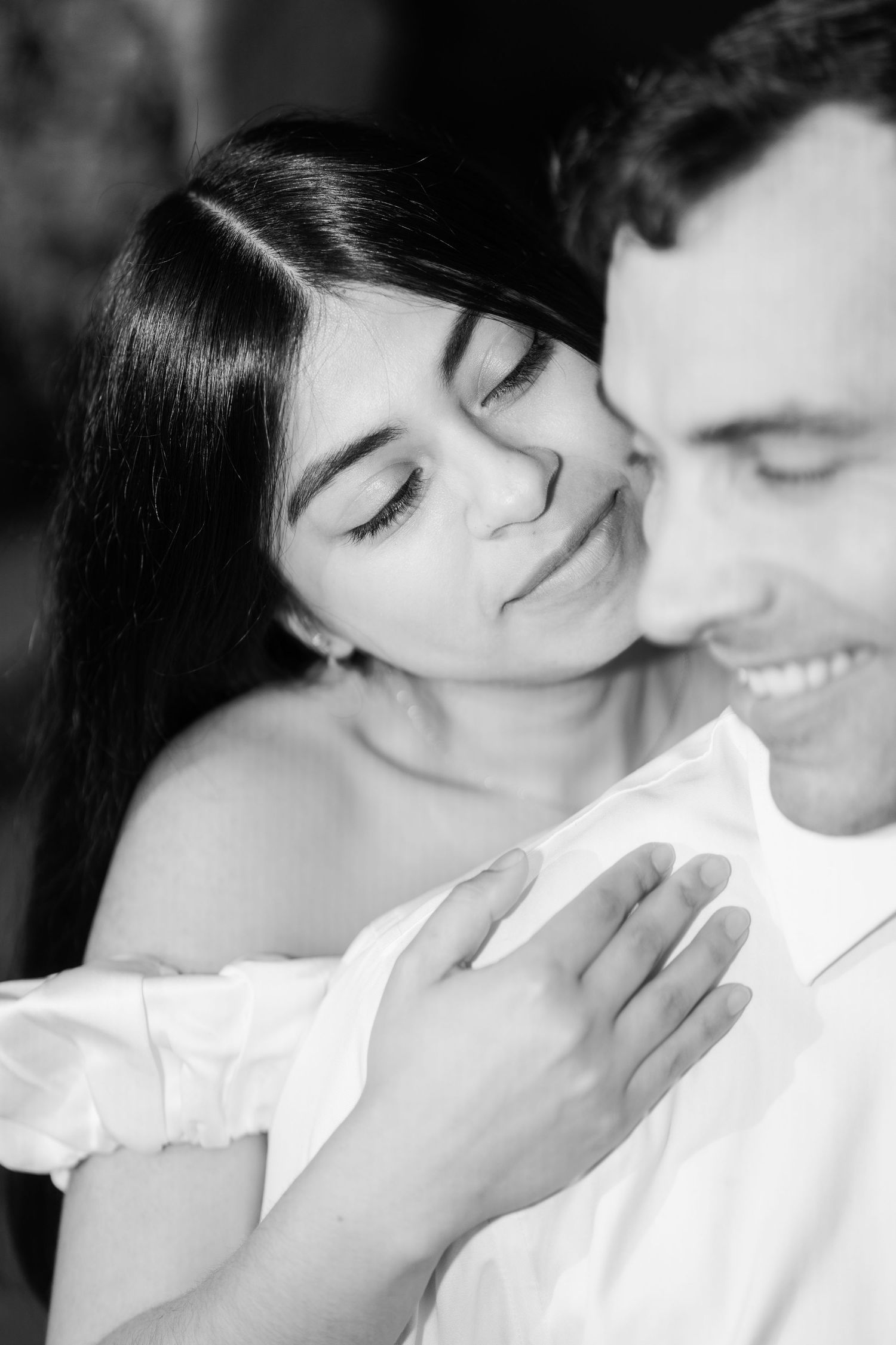 Couple embracing during a romantic black and white engagement session by Connecticut wedding photographer Concetta Codding.