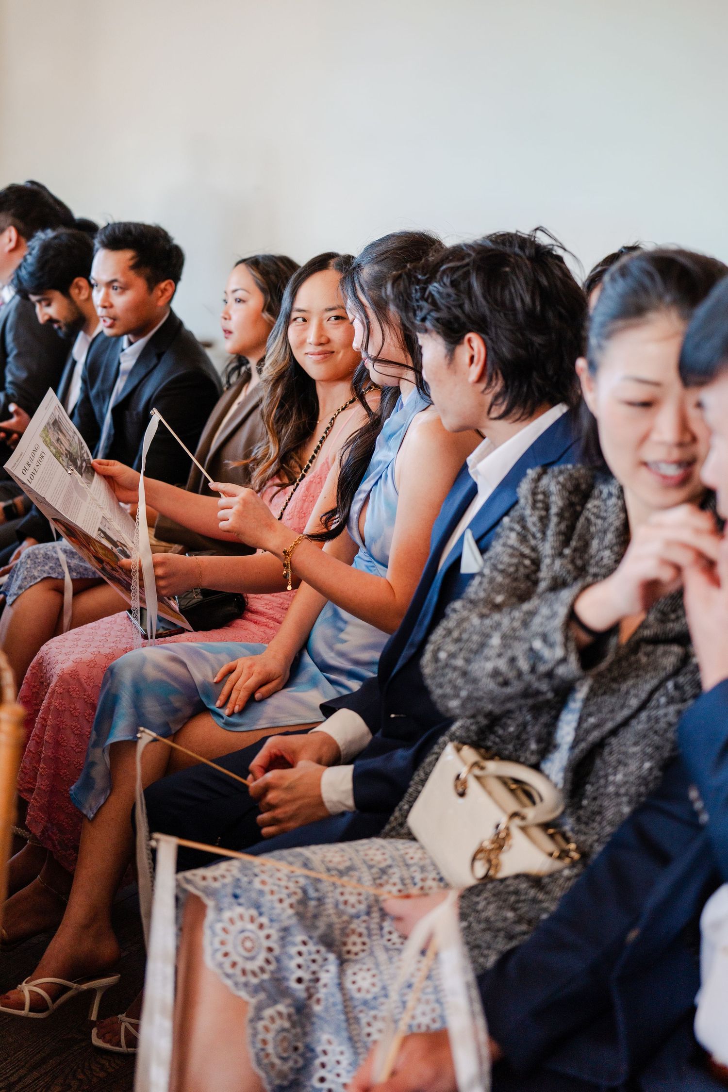 Wedding guests smiling during the ceremony at a destination wedding celebration.