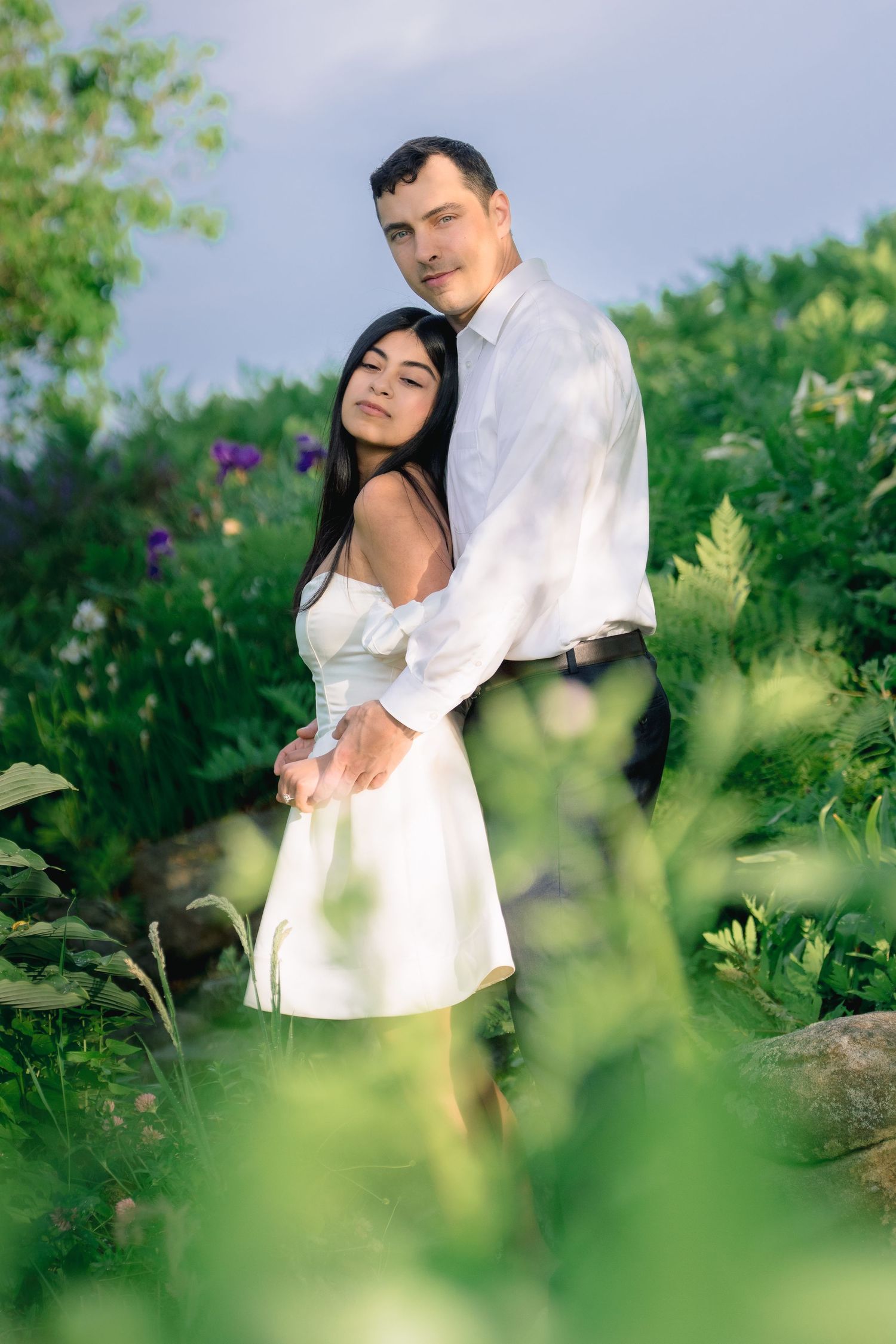 Romantic couple portrait surrounded by lush gardens during a Harkness Memorial State Park engagement session in Waterford, Connecticut.