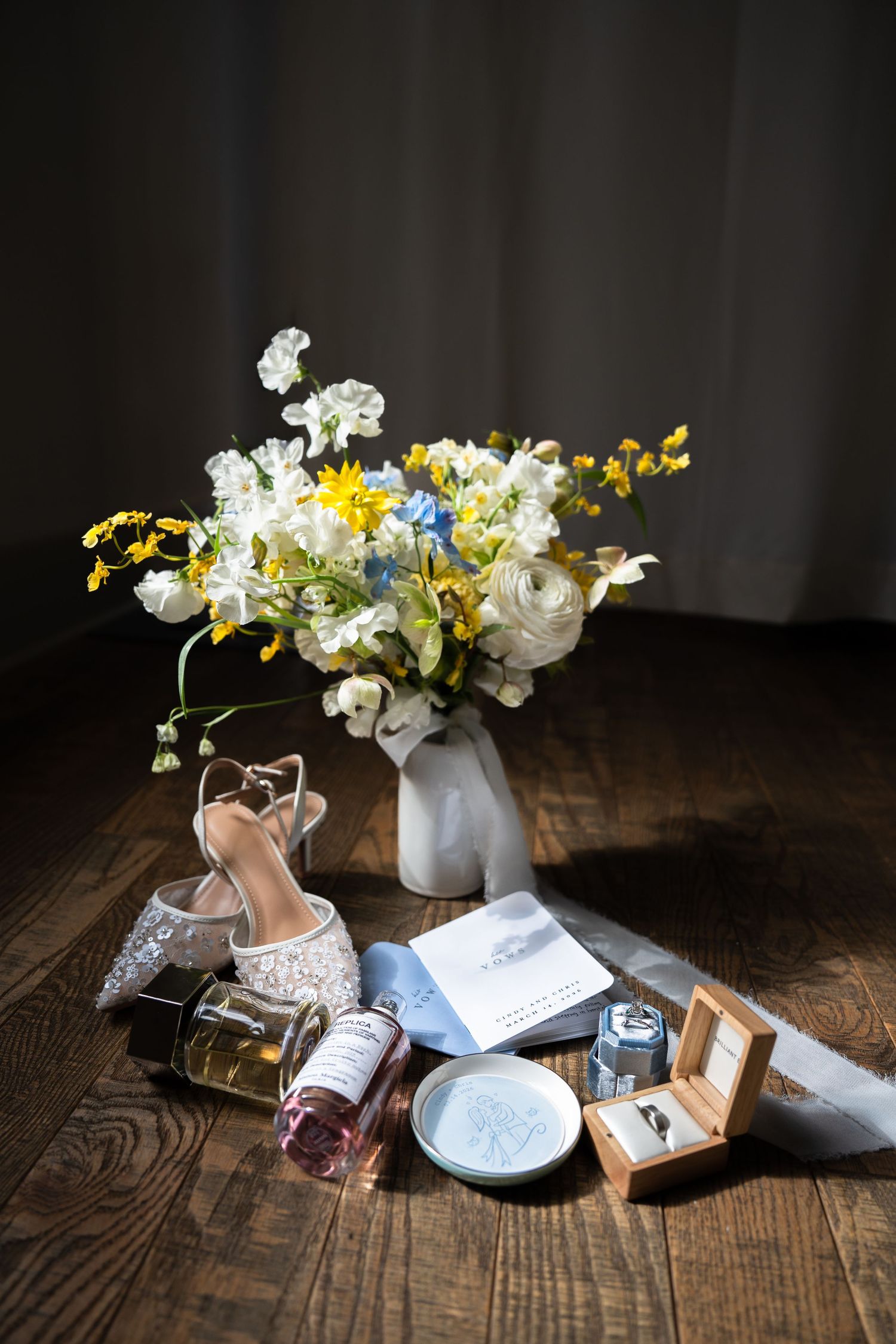 flat lay in Hudson Valley New York area ft. beautiful florals, perfume, and bridal shoes at a wedding
