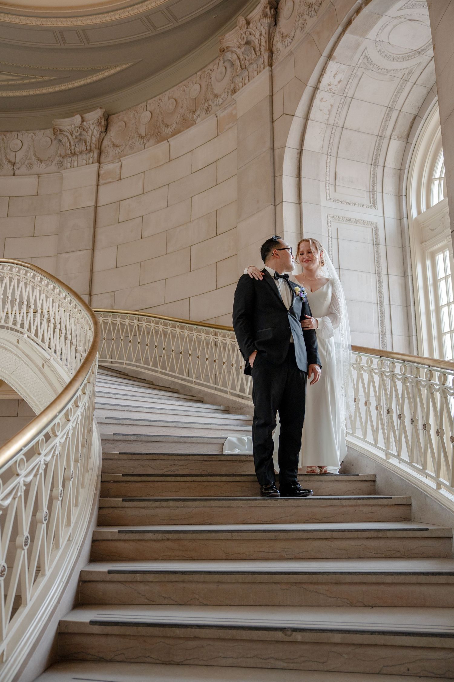 Bride and groom standing on the historic staircase during a Hartford City Hall elopement in Hartford, Connecticut.