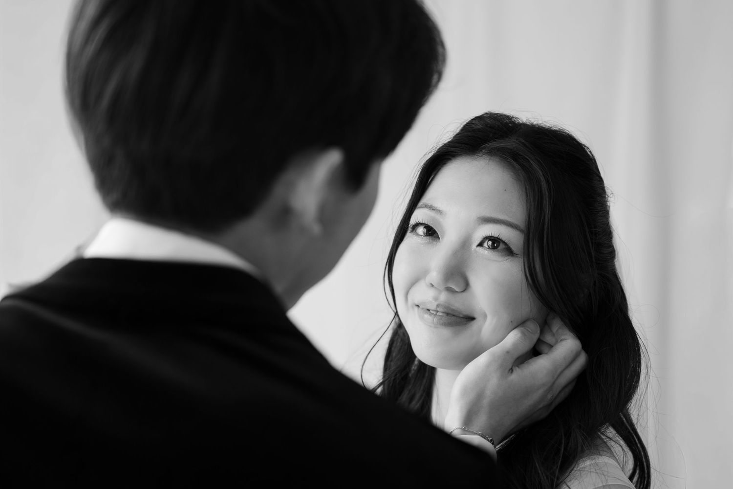 Black and white portrait of a couple sharing a quiet moment during a wedding day.