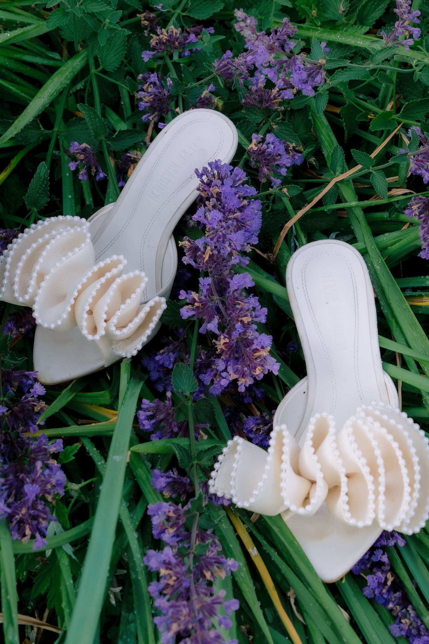 Bridal shoes photographed among flowers during an engagement session at Harkness Memorial State Park in Connecticut.