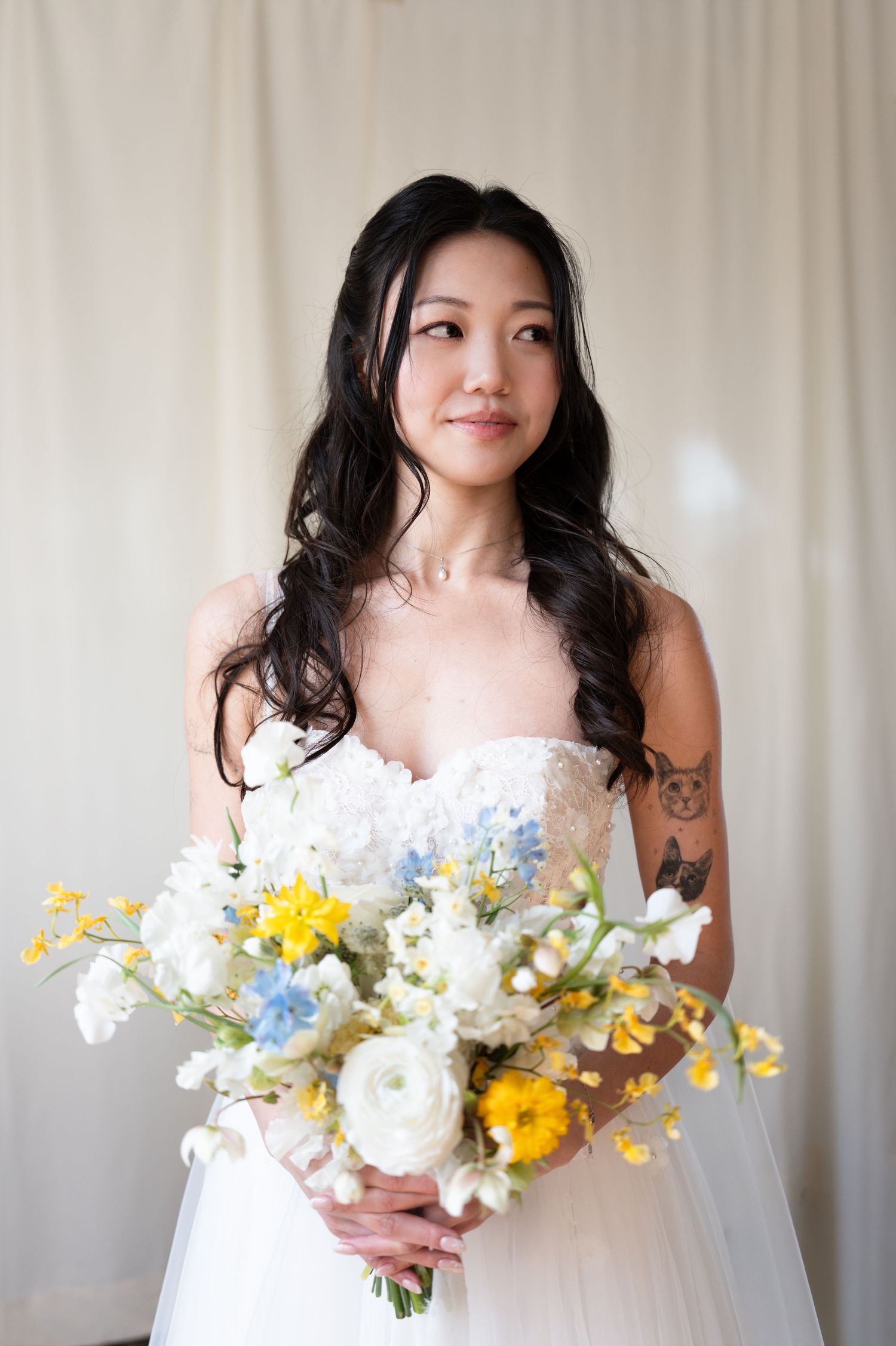 Bride holding a bouquet during a wedding portrait before the ceremony.
