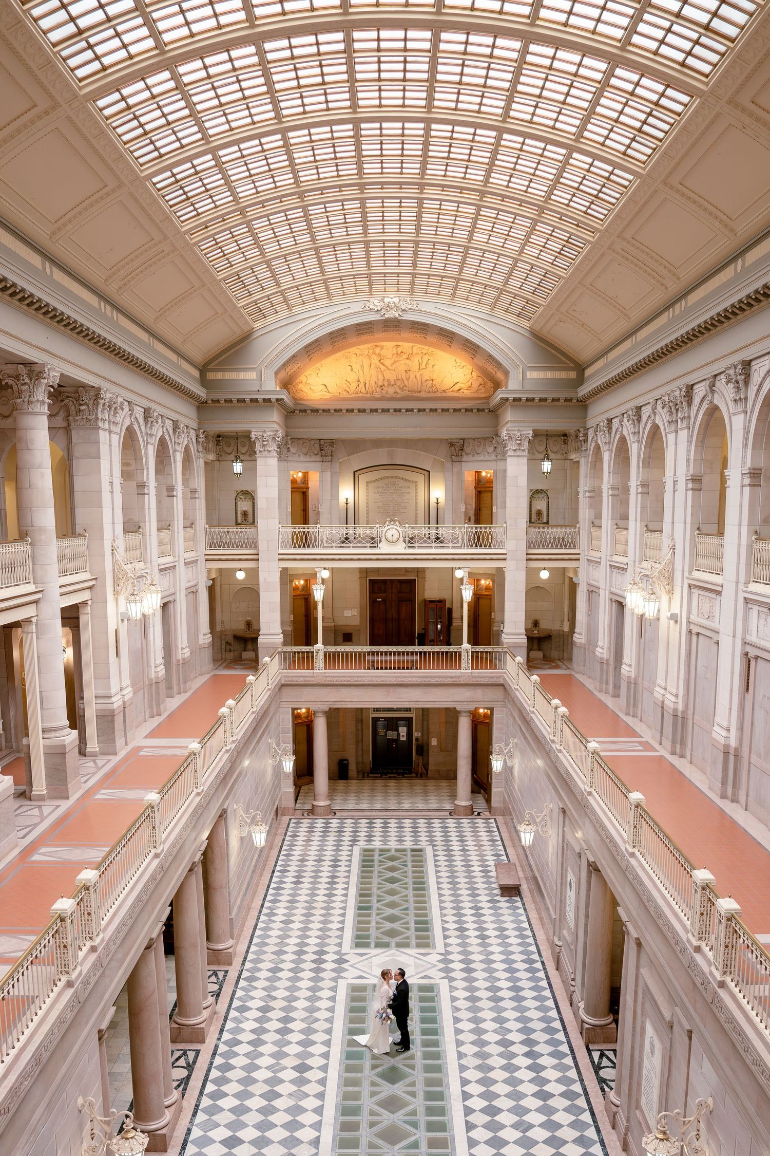 Bride and groom standing beneath the grand atrium during a Hartford City Hall elopement in Hartford, Connecticut.