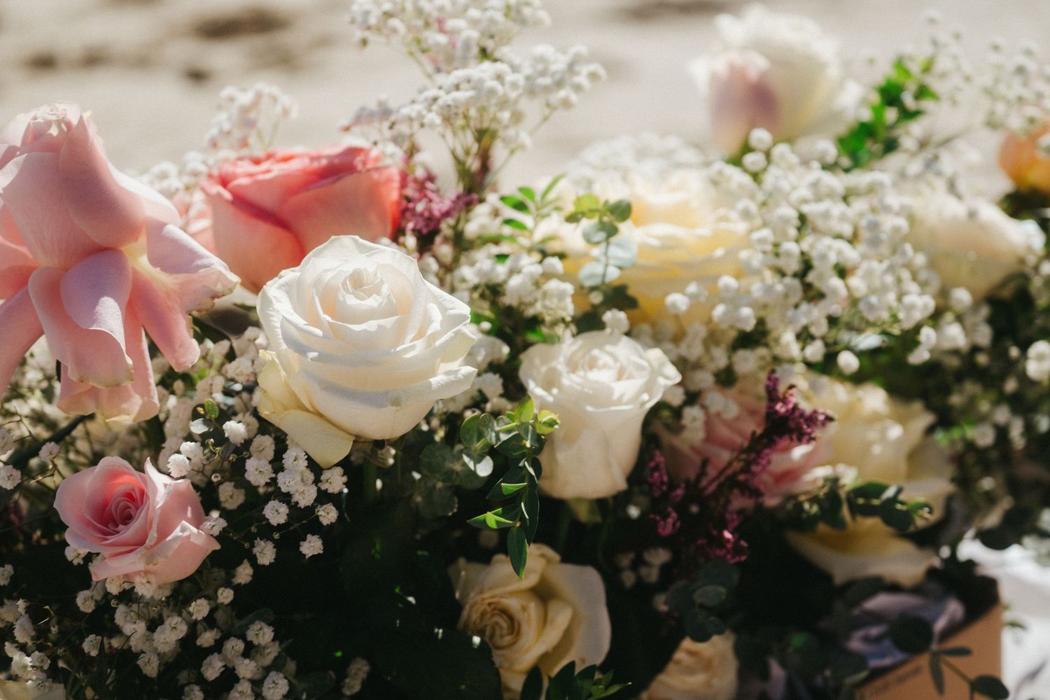 Close-up of elegant pink and white roses with baby's breath bouquet.