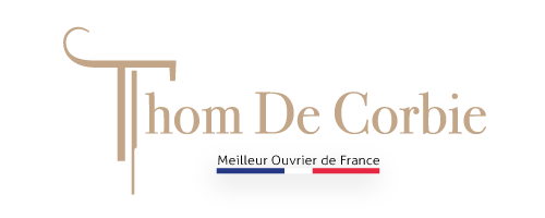 Thom De Corbie logo with elegant typography and Meilleur Ouvrier de France distinction badge.