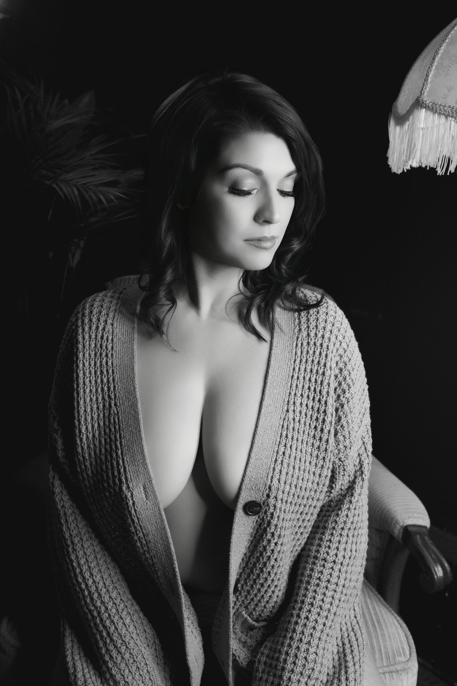 Elegant black and white boudoir portrait with soft shadows and timeless styling.
