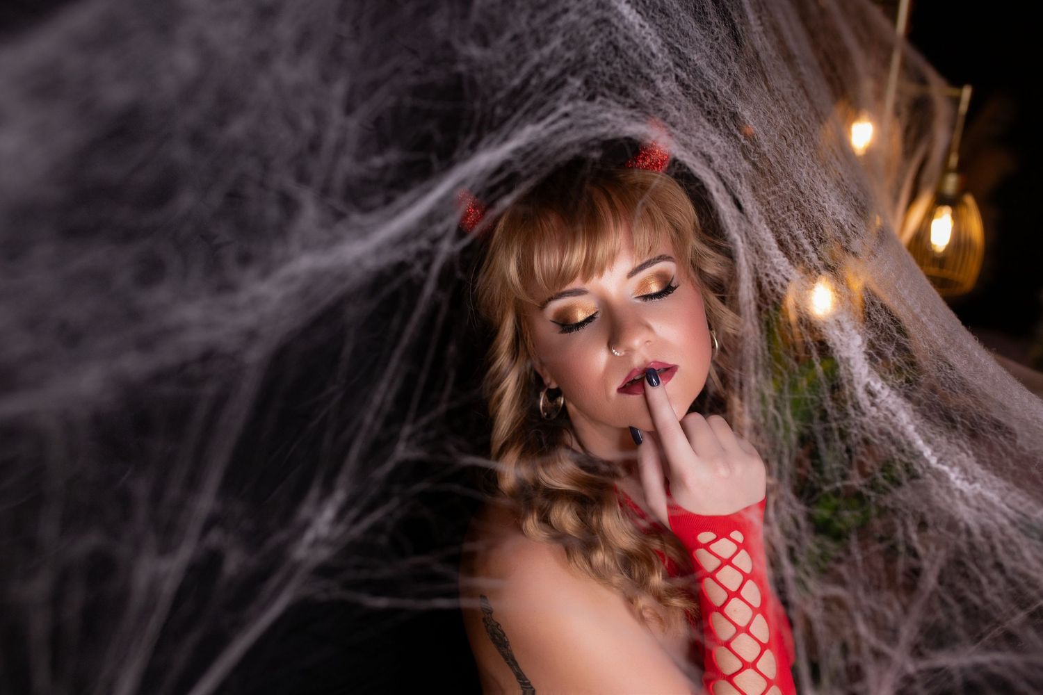 Creative boudoir photography portrait with dramatic styling and artistic lighting.