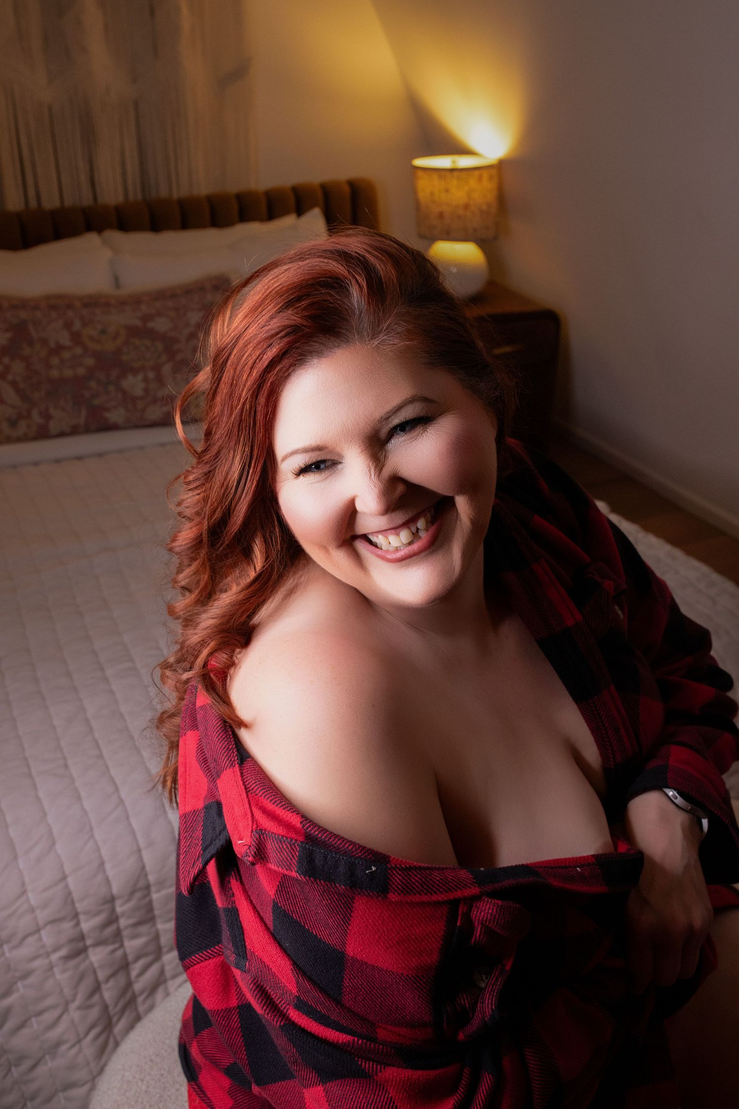 Woman smiling during a luxury Airbnb boudoir photography session.
