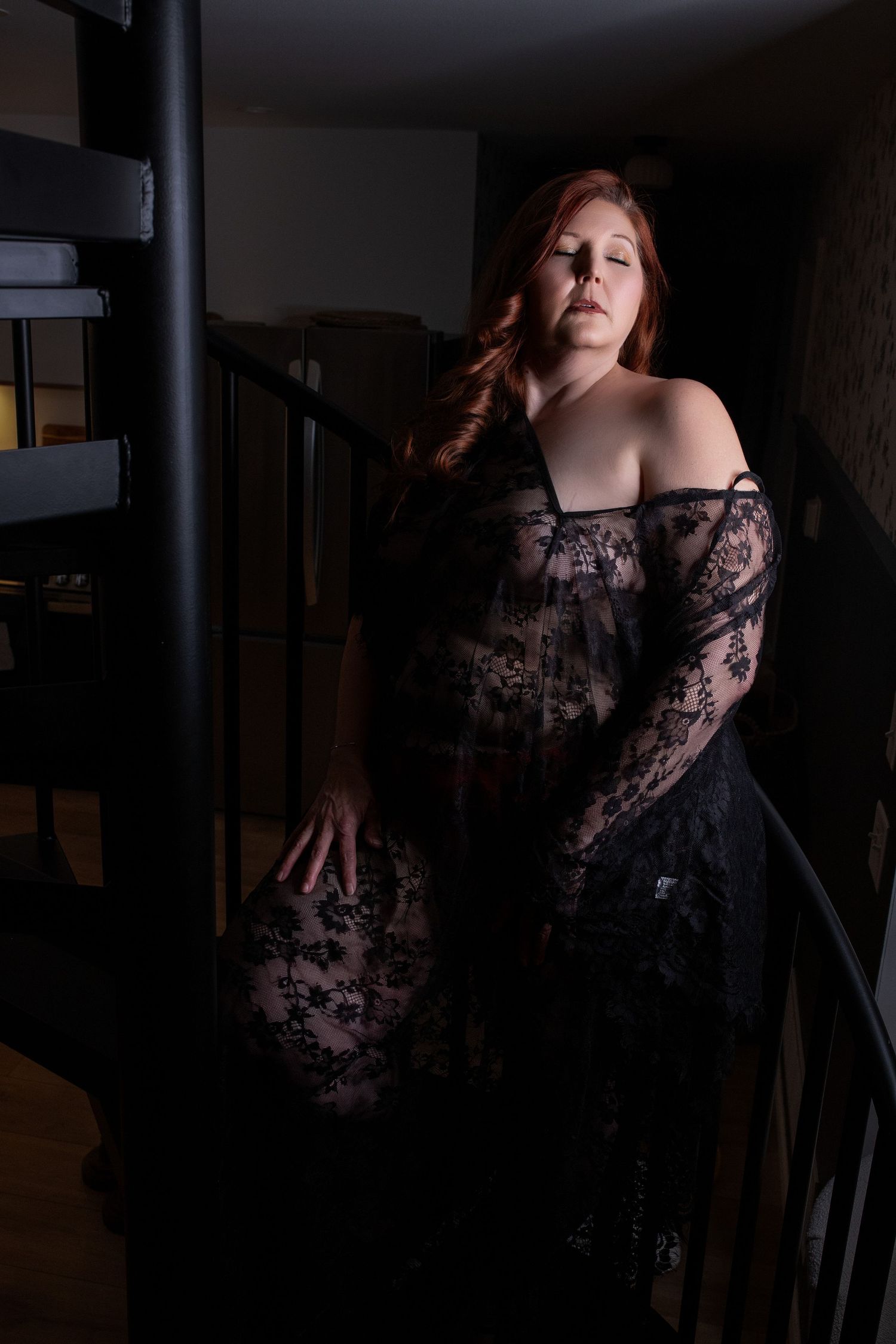 Moody studio boudoir portrait highlighting confidence and feminine beauty.