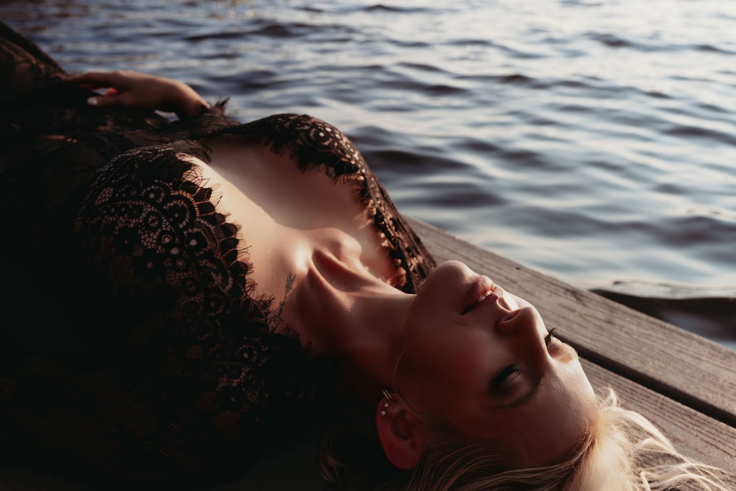 Boudoir portrait of a woman on a pier by Lake Wisconsin.