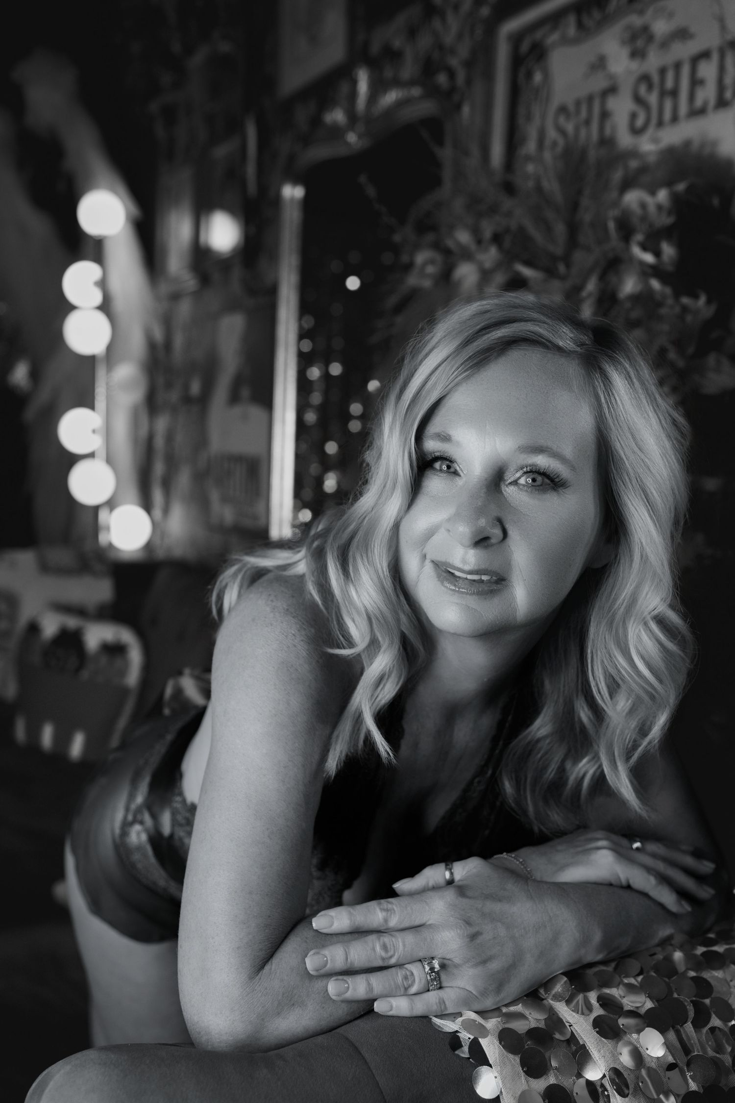 Elegant black and white portrait of woman in a luxury boudoir photography session.