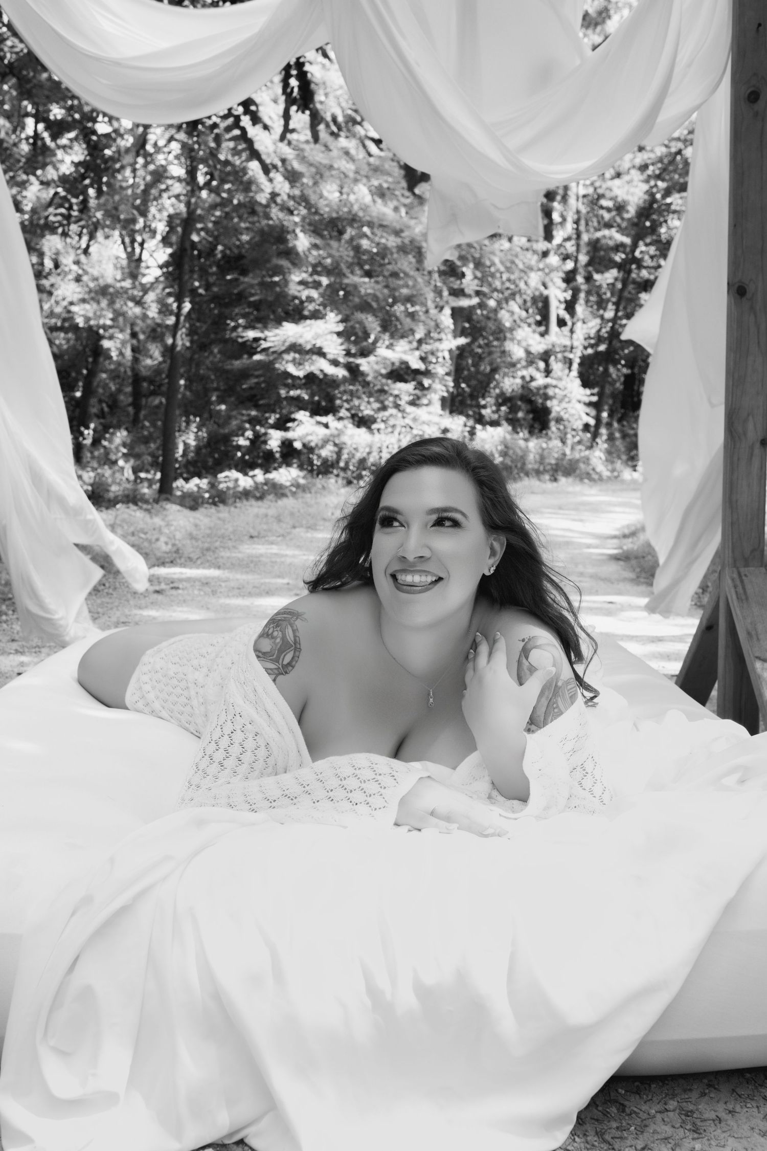 Outdoor black and white image of a woman during her boudoir session.